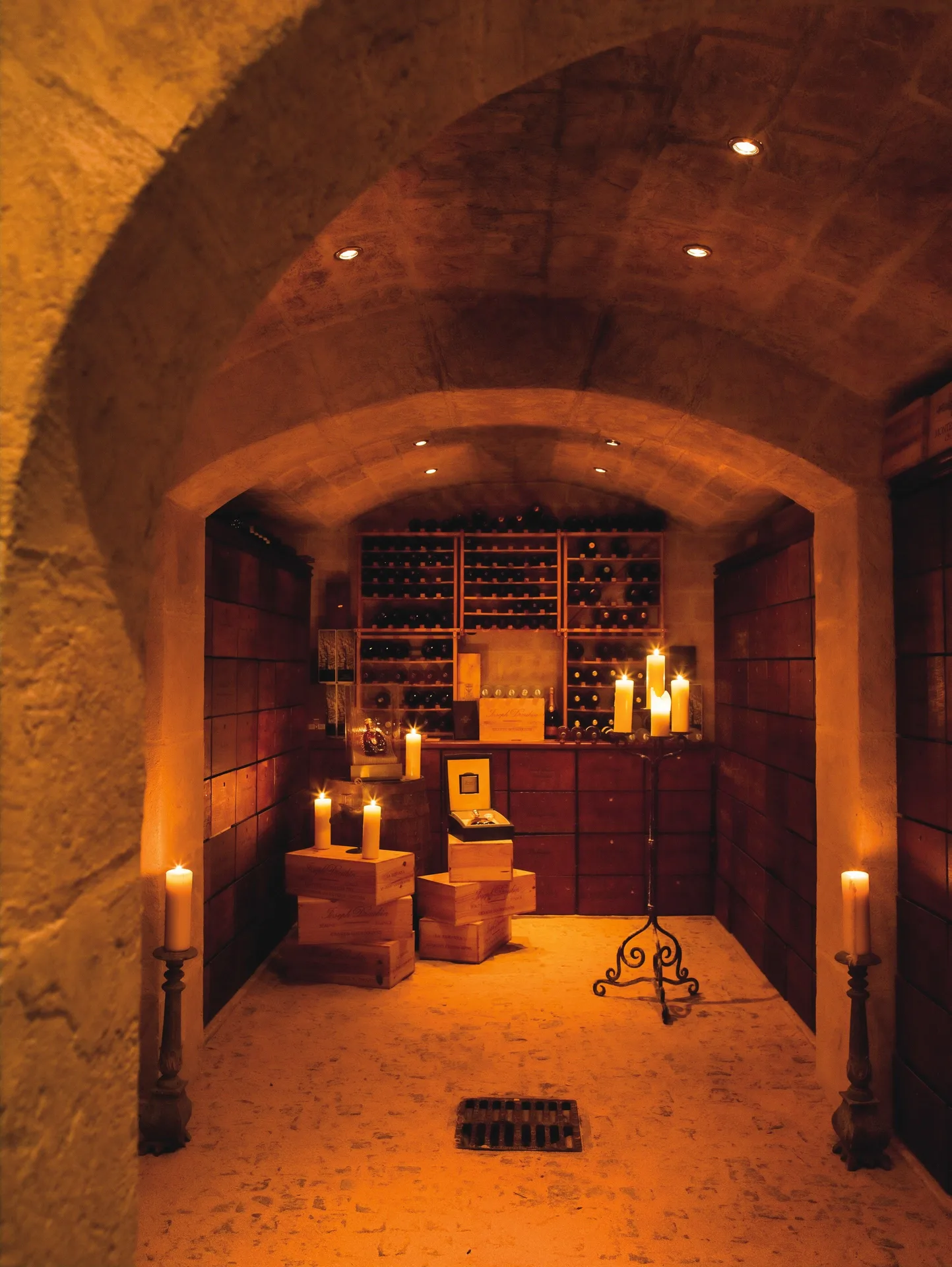 Candlelit stone wine cellar with bottle racks at La Samanna, St Martin.