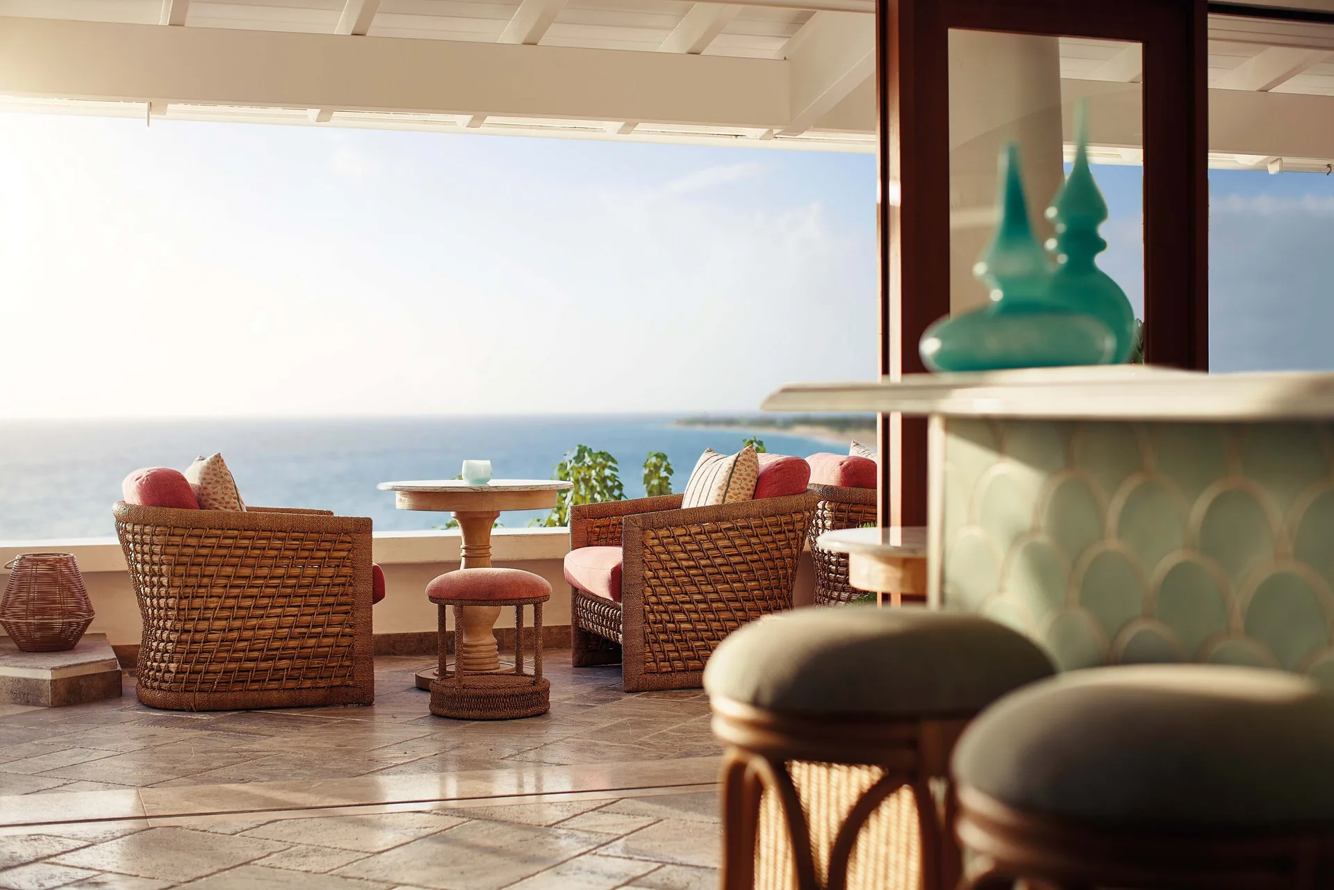 Open-air lounge with wicker seating and an ocean view at La Samanna, St Martin.