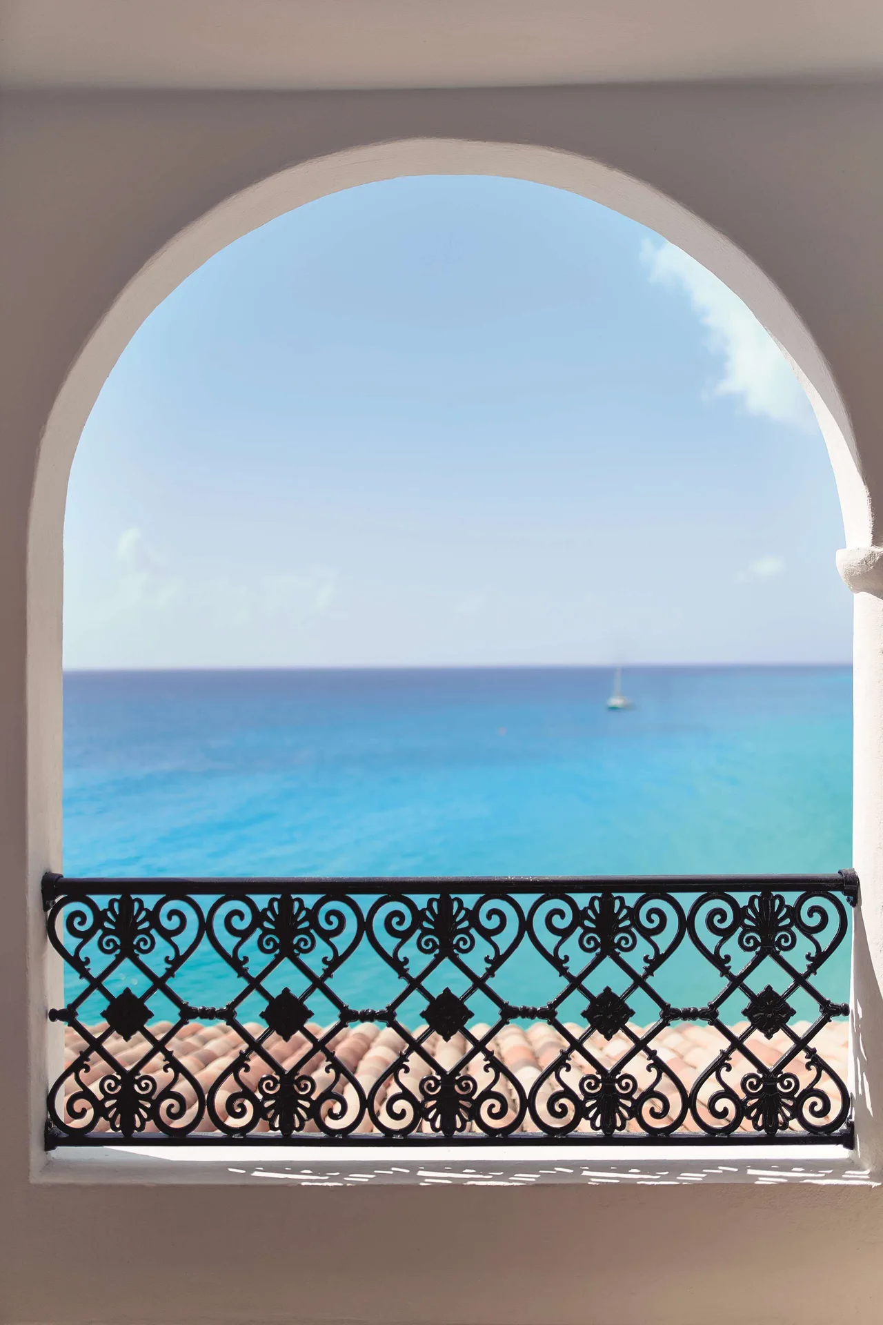 Deluxe Room Ocean View arch balcony with turquoise water at La Samanna, St Martin.