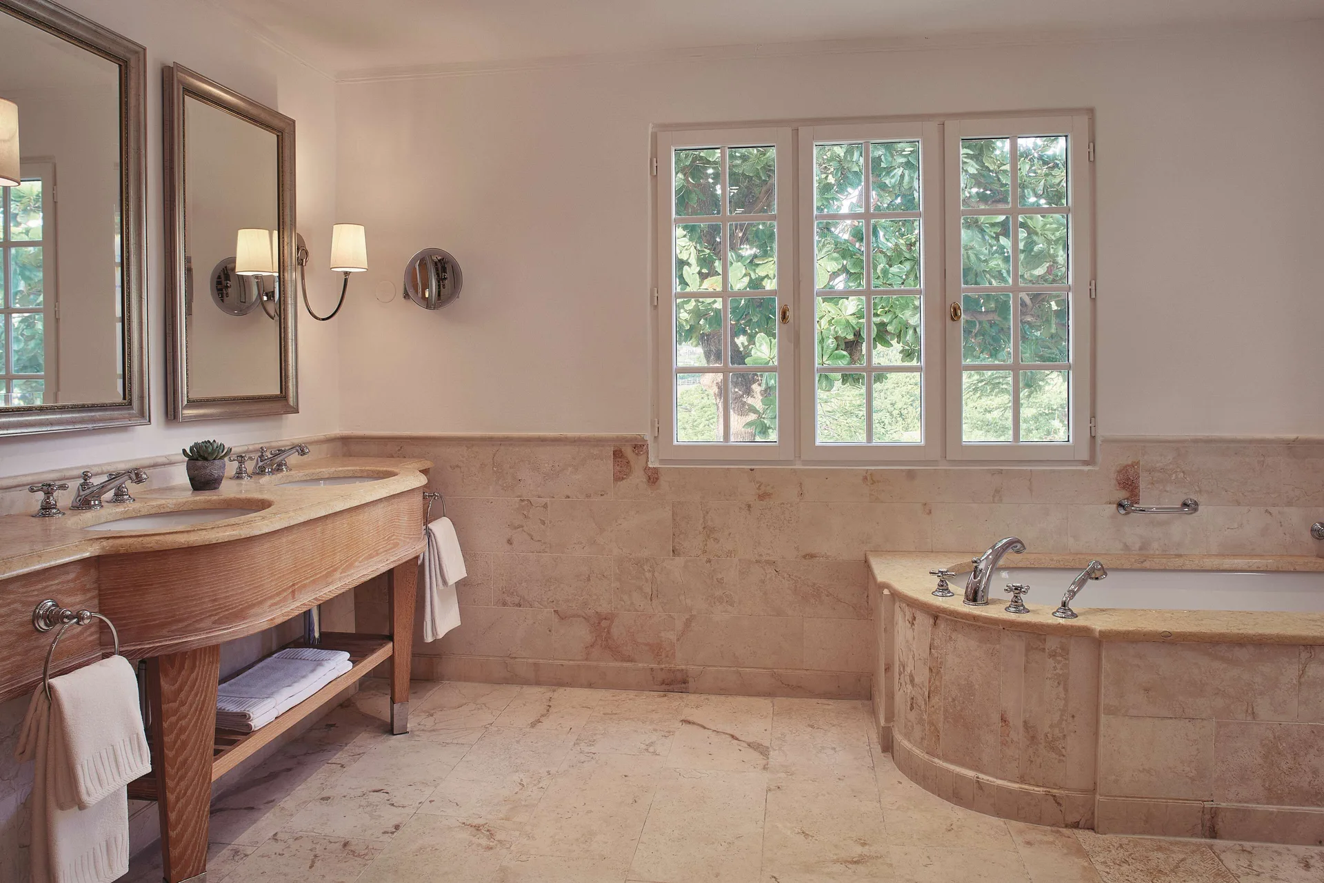 Marble bathroom with double vanity and soaking tub in a suite at La Samanna, St Martin.
