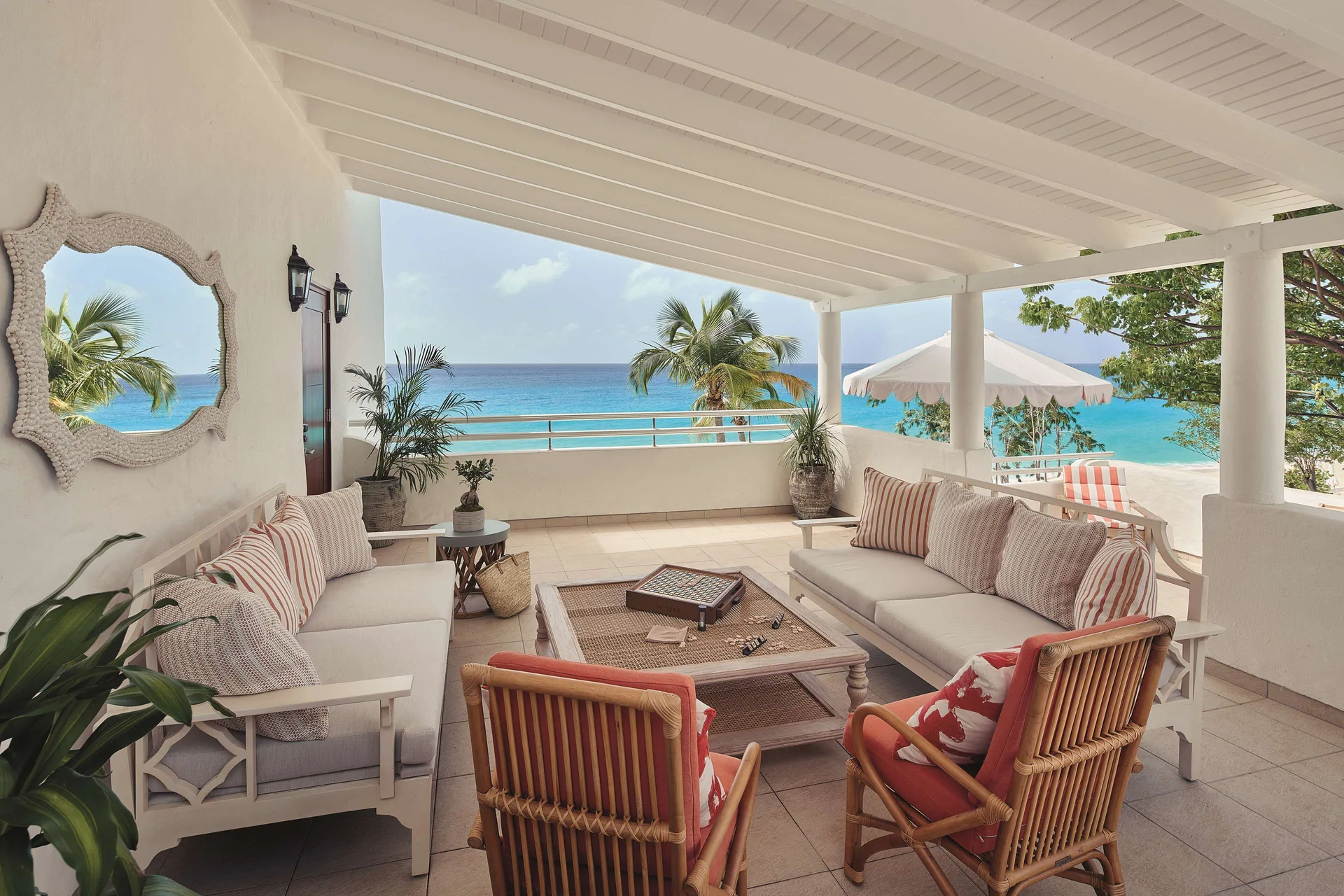 Covered terrace lounge with ocean views at a one-bedroom suite at La Samanna, St Martin.