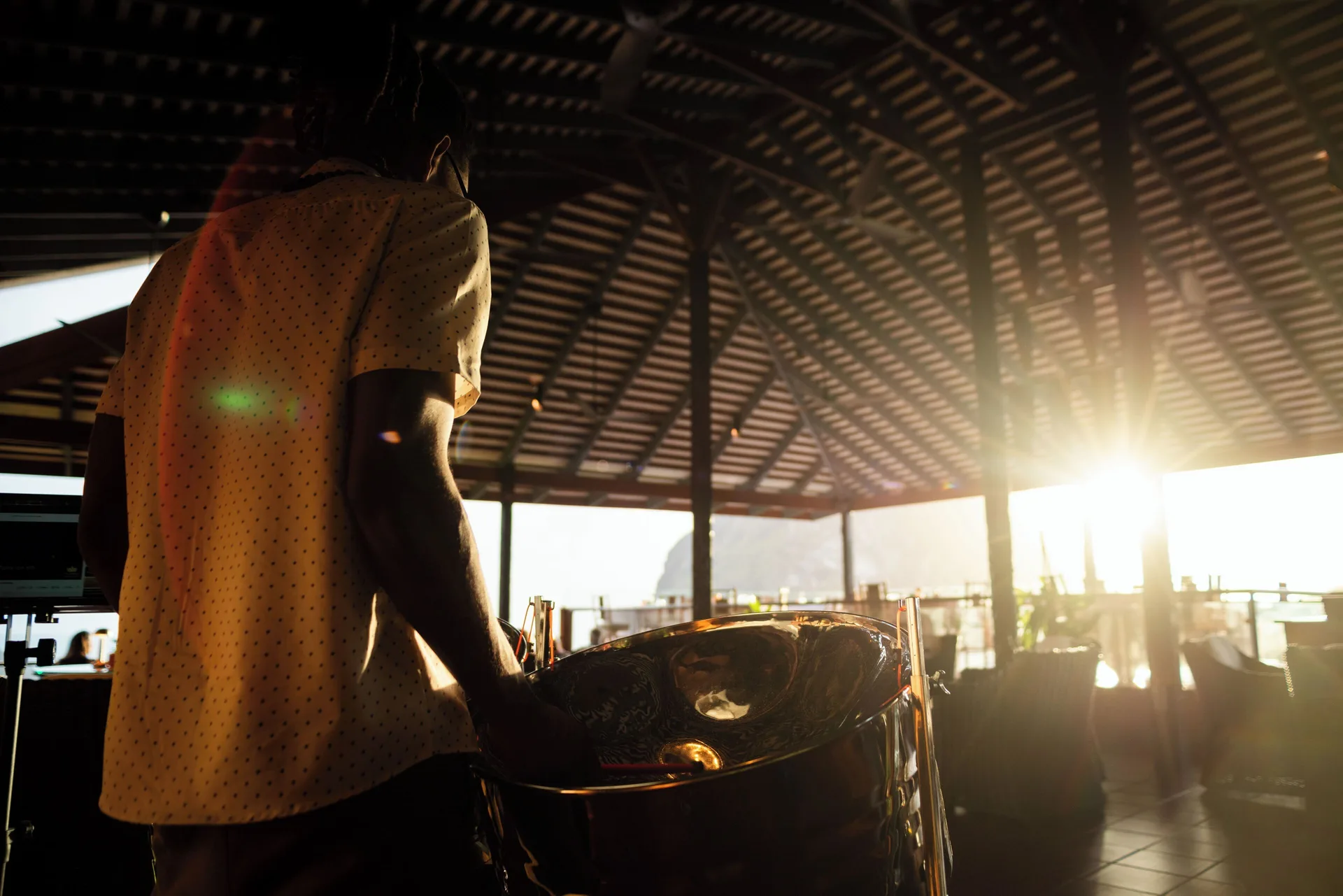 Musician playing steel pan in an open-air venue at sunset at Ladera Resort.