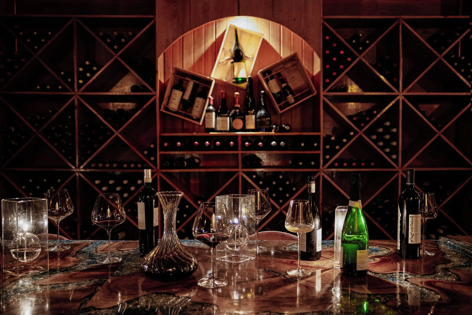 Wine bottles and tasting glasses are arranged in a wine room at Ladera Resort.
