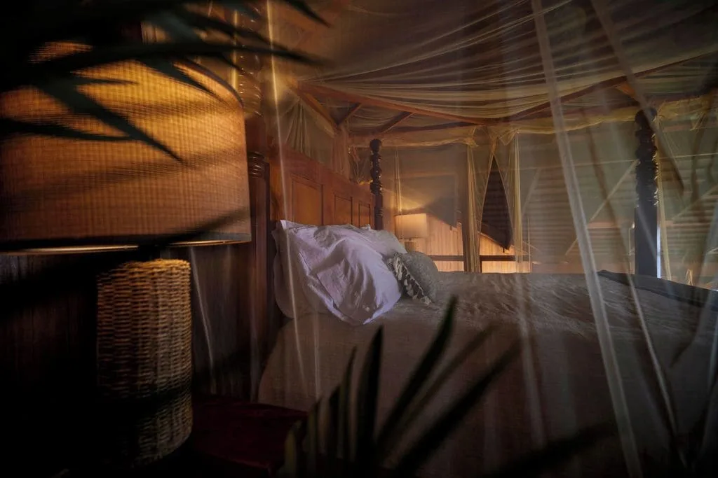 Heritage Suite bed seen through sheer netting at Ladera Resort.