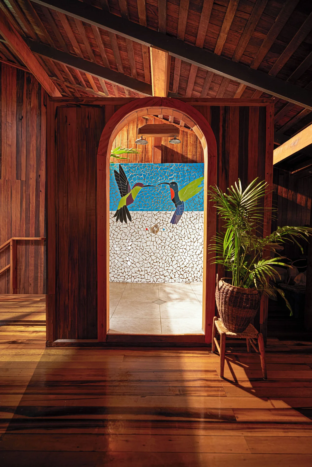 Heritage Suite shower entrance with hummingbird mosaic at Ladera Resort.