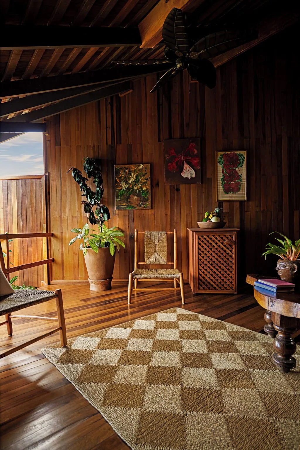 Heritage Suite sitting area with wood walls and plants at Ladera Resort.