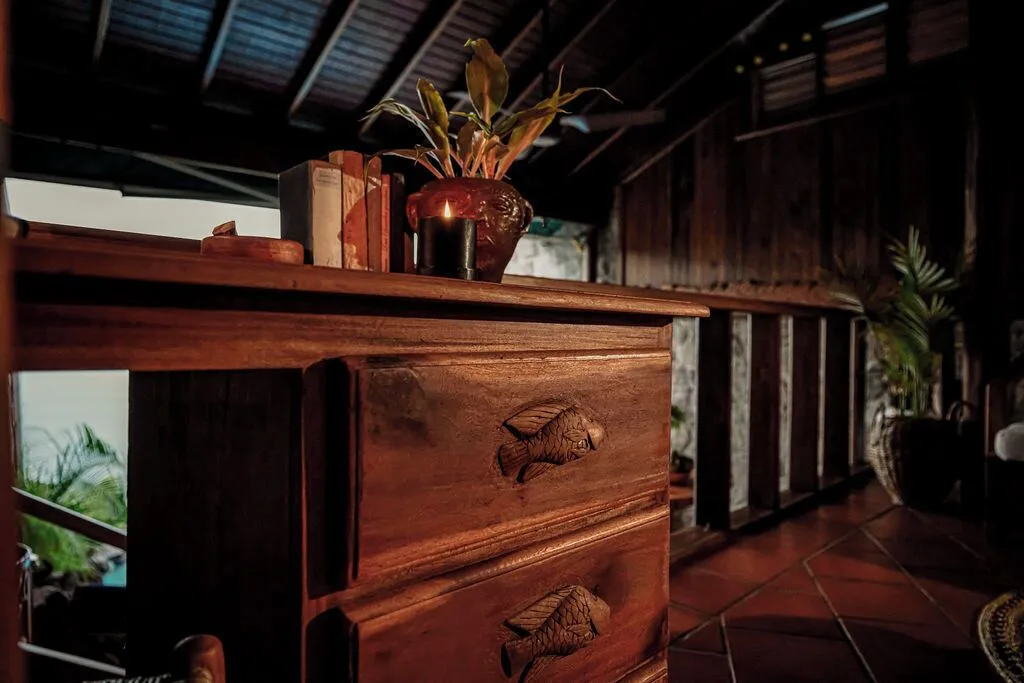 Wooden chest with carved fish details in a Hilltop Dream Suite at Ladera Resort.
