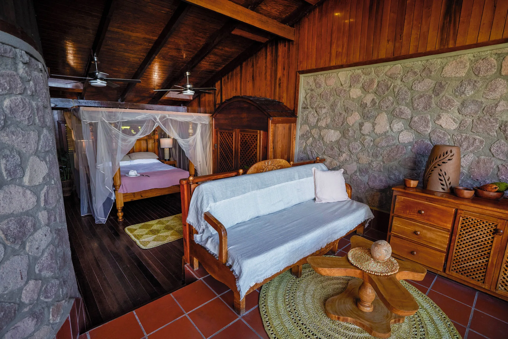 Petit Piton Suite living area and canopy bed at Ladera Resort.