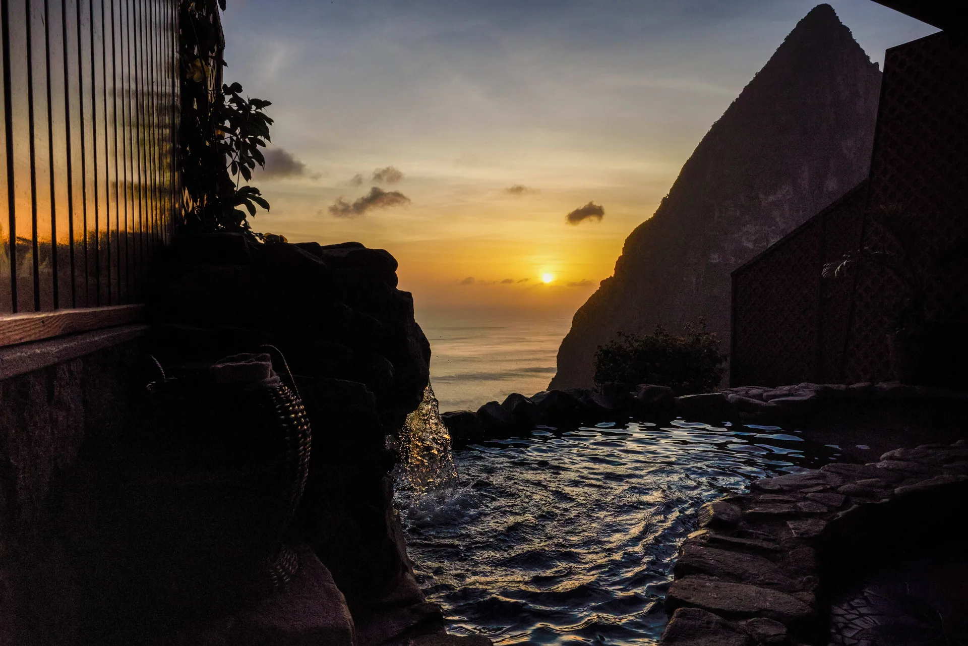 Rainbow Suite plunge pool at sunset with Piton silhouette and sea view at Ladera Resort.