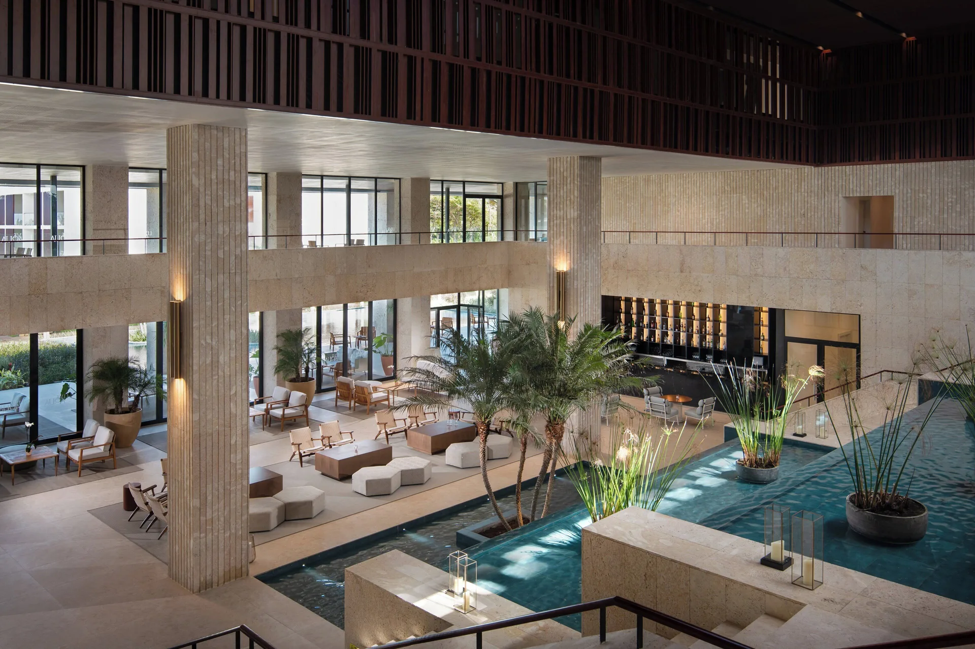 Indoor reflecting pools and lounge seating in the lobby at Live Aqua Punta Cana.