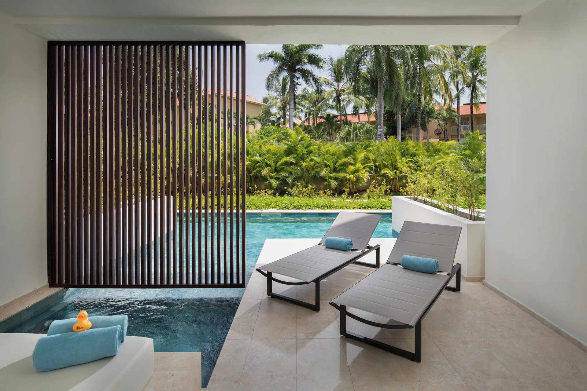 Aqua Junior Suite terrace loungers by the swim-up pool at Live Aqua Punta Cana.
