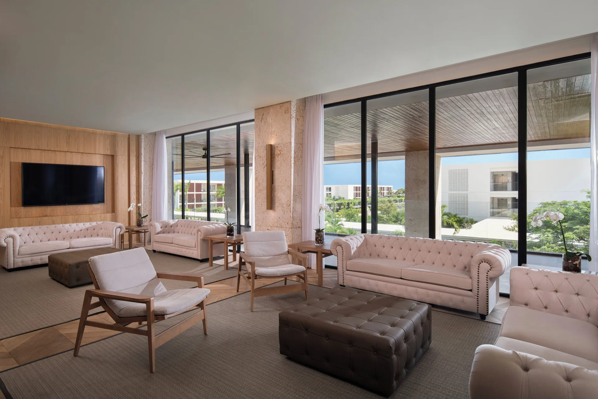 Lobby lounge with sofas and large windows at Live Aqua Punta Cana.
