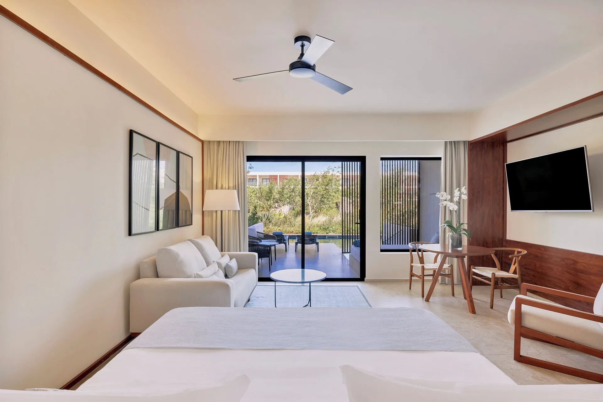 Aqua Junior Suite Swim-Up Pool View king bed and sitting area at Live Aqua Punta Cana.