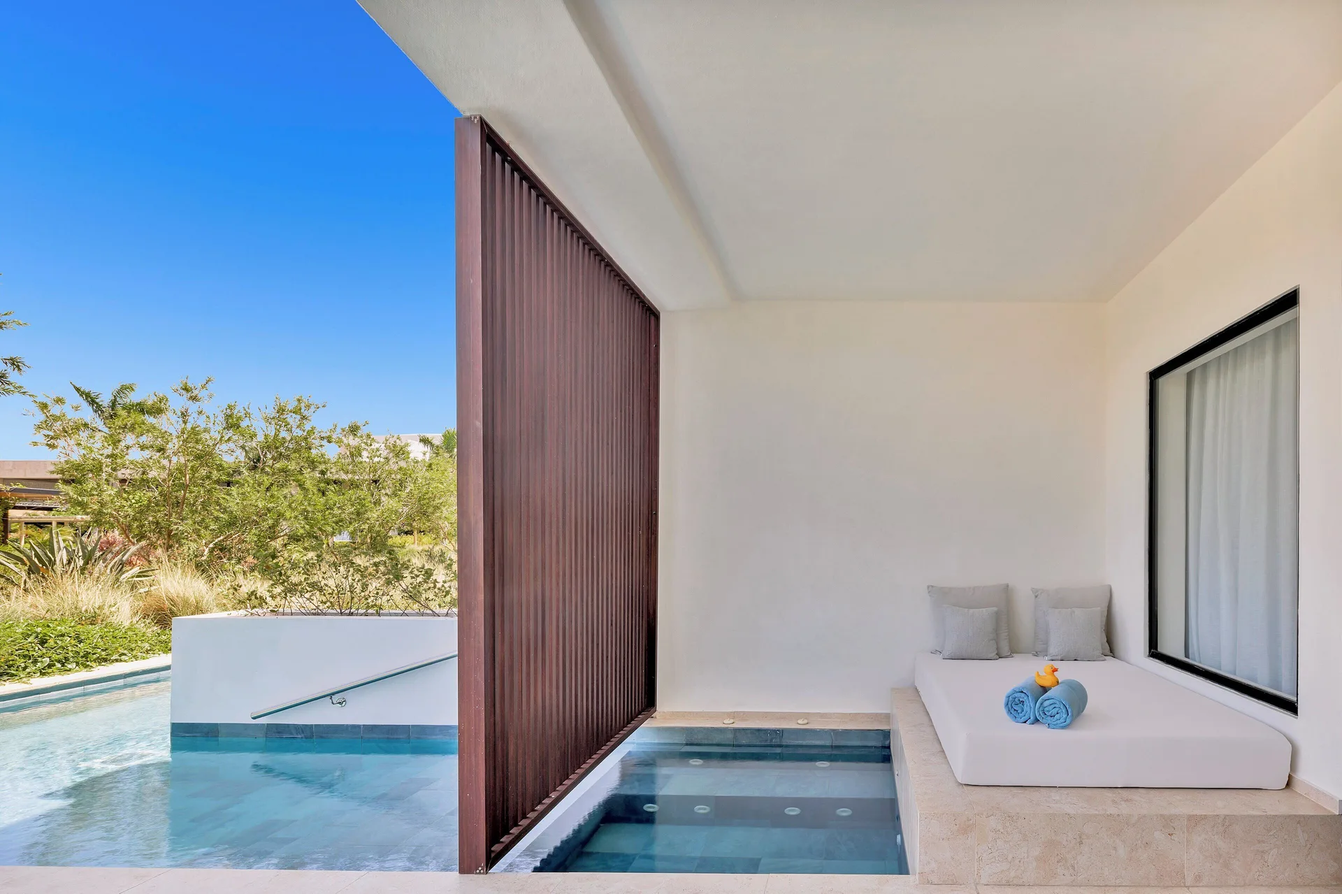 Aqua Junior Suite Swim-Up Pool View terrace daybed at Live Aqua Punta Cana.