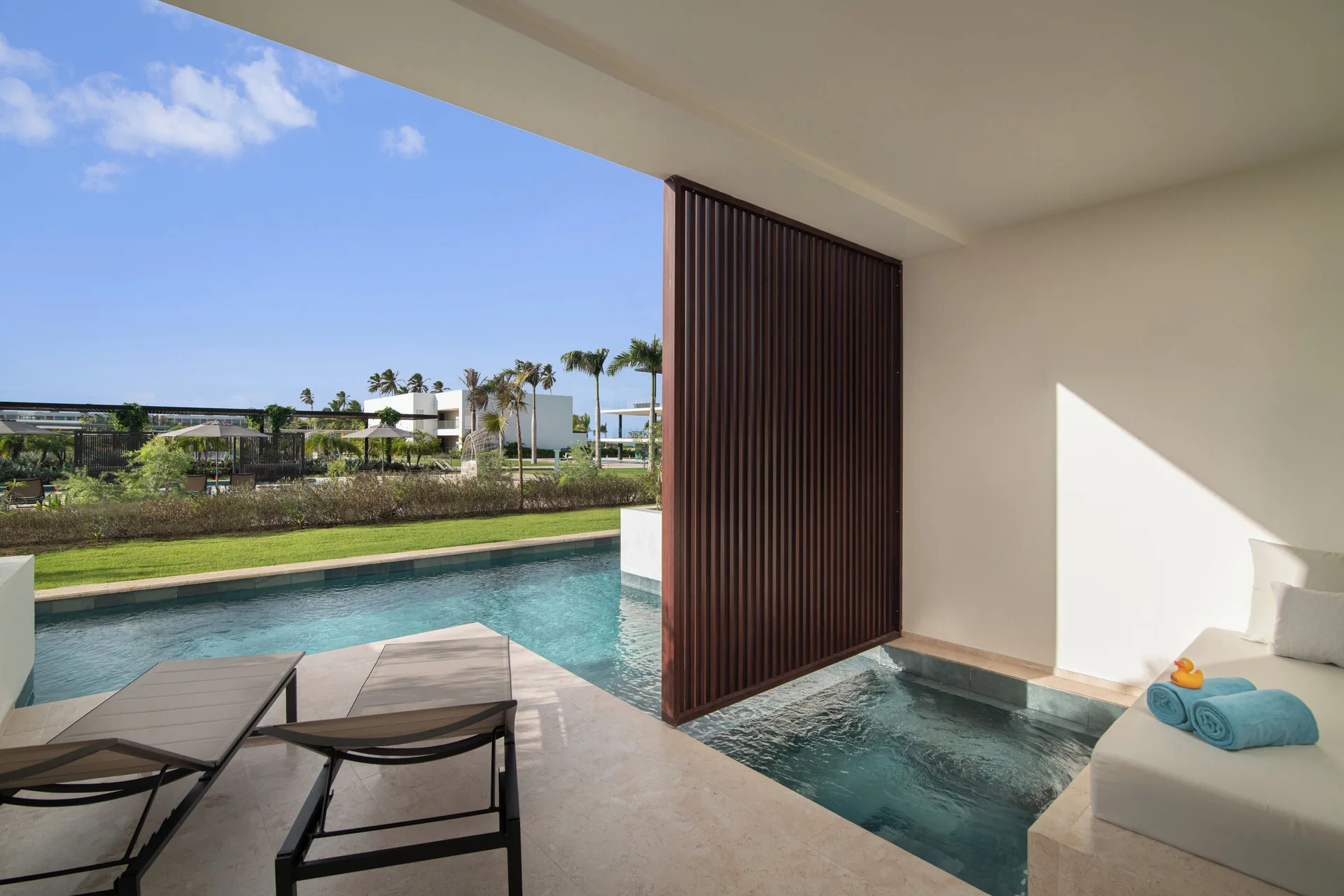 Aqua Junior Suite Swim-Up Pool View terrace loungers and pool at Live Aqua Punta Cana.