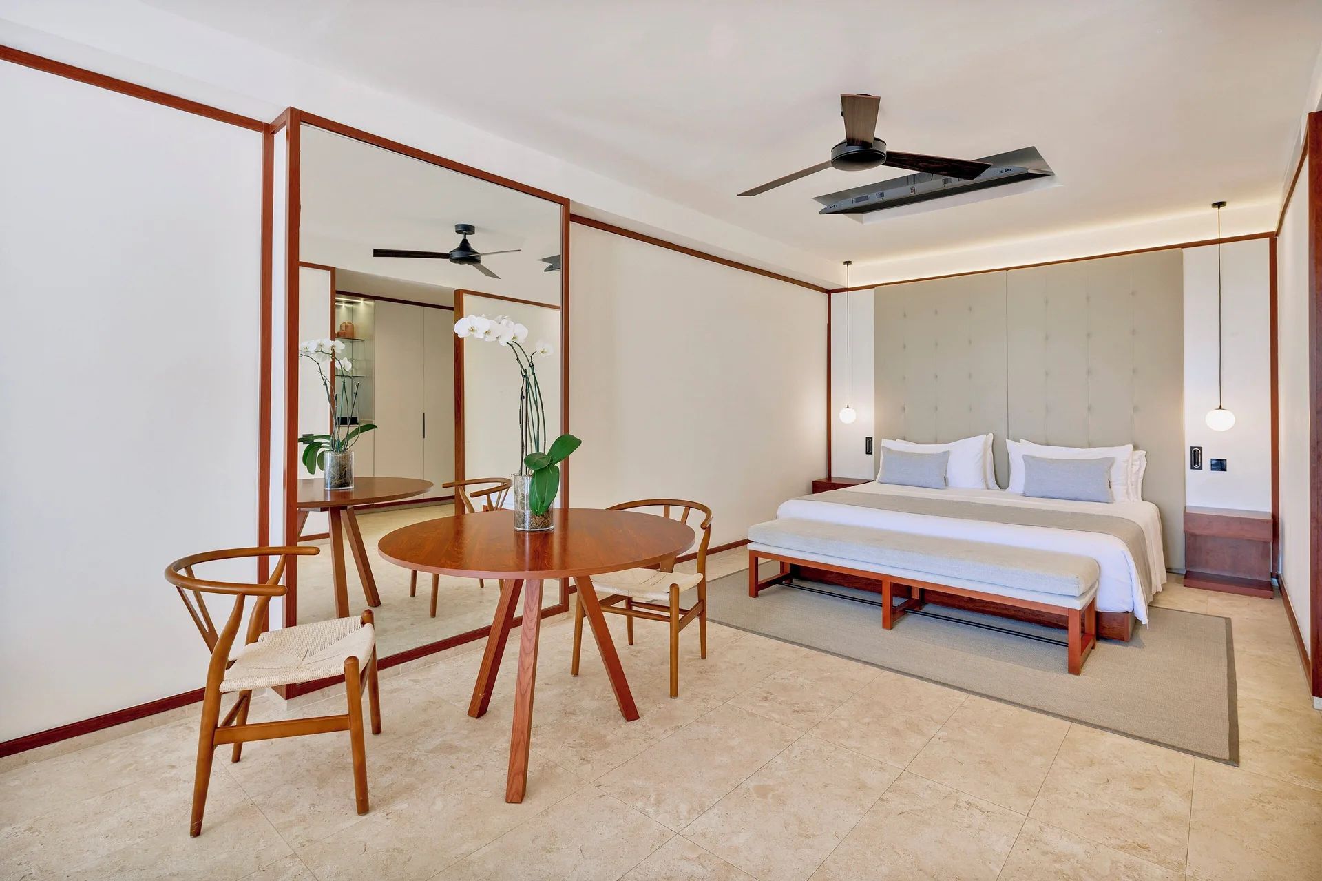 Fuego Suite Partial Ocean View dining table and king bed at Live Aqua Punta Cana.