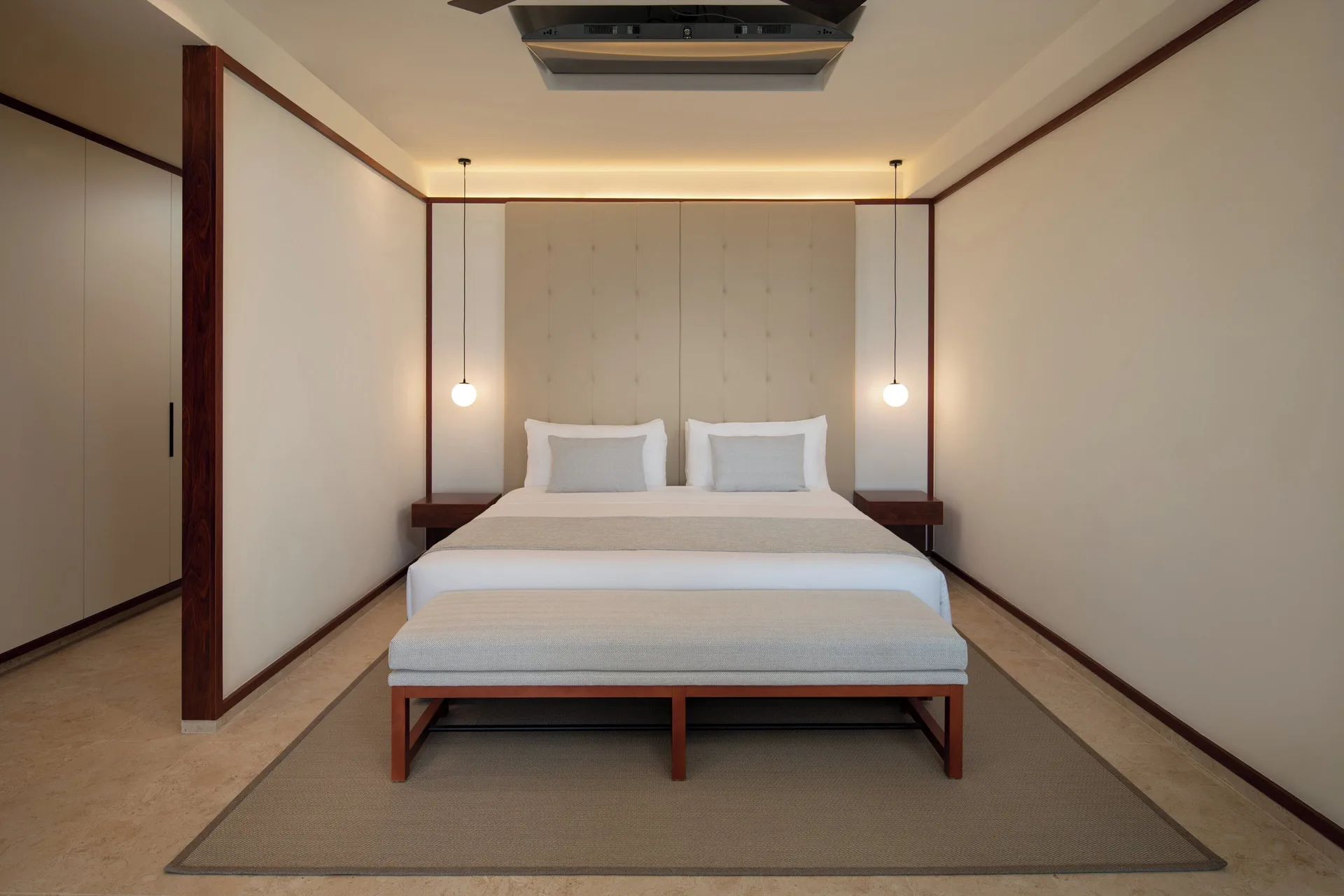 Fuego Suite Partial Ocean View king bed and bench at Live Aqua Punta Cana.