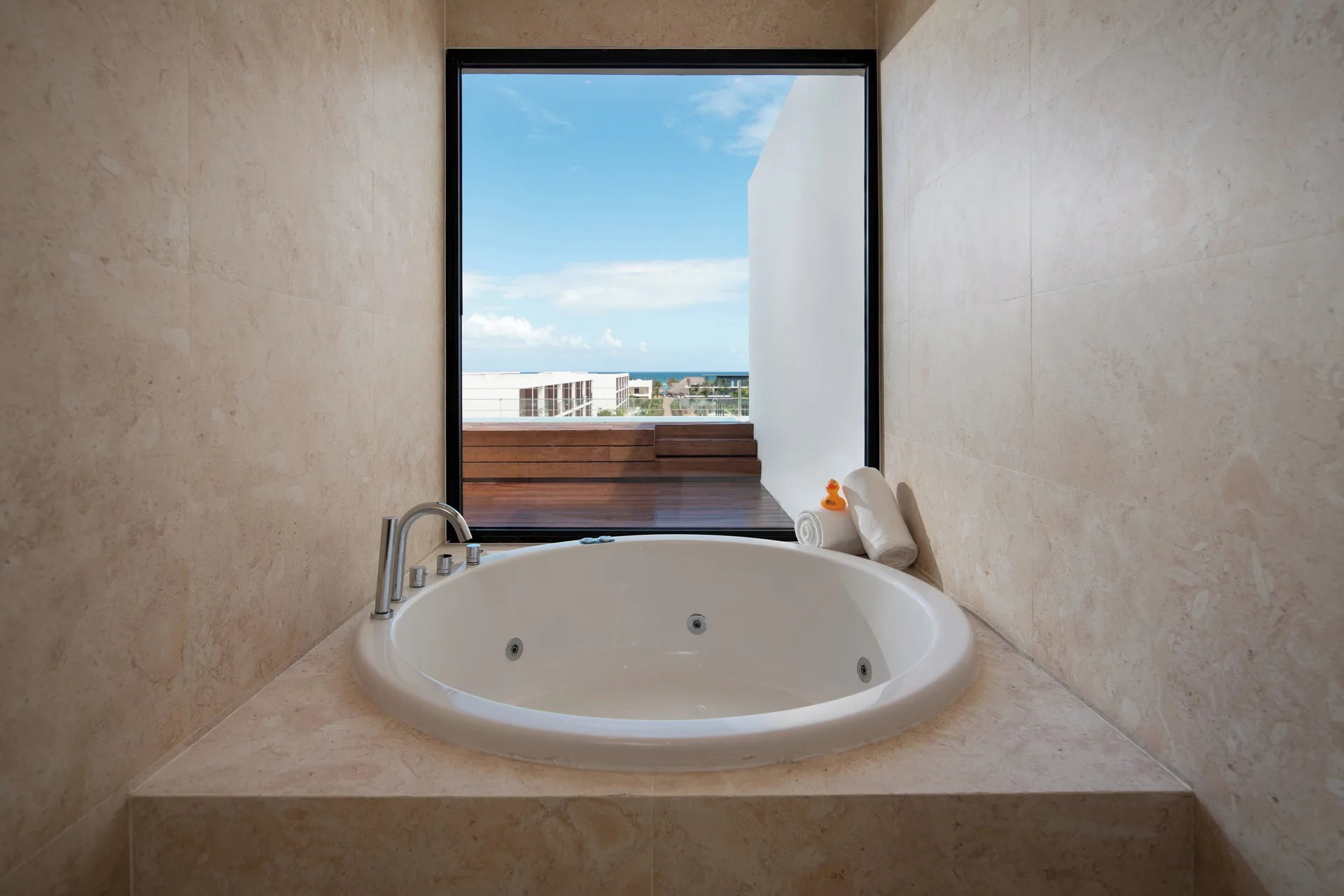 Fuego Suite Partial Ocean View soaking tub faces a large window at Live Aqua Punta Cana.