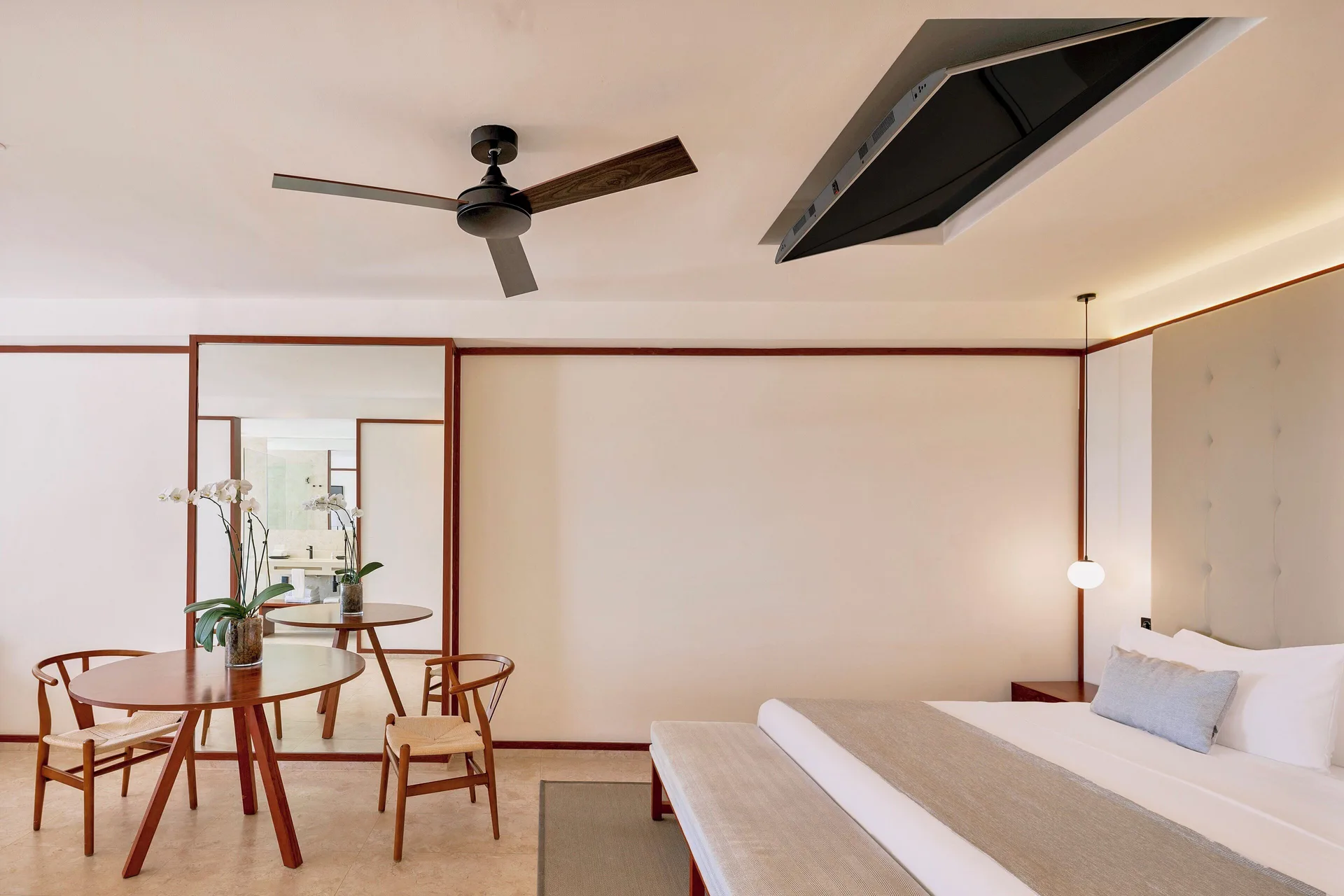 Fuego Suite Partial Ocean View table beside the king bed at Live Aqua Punta Cana.