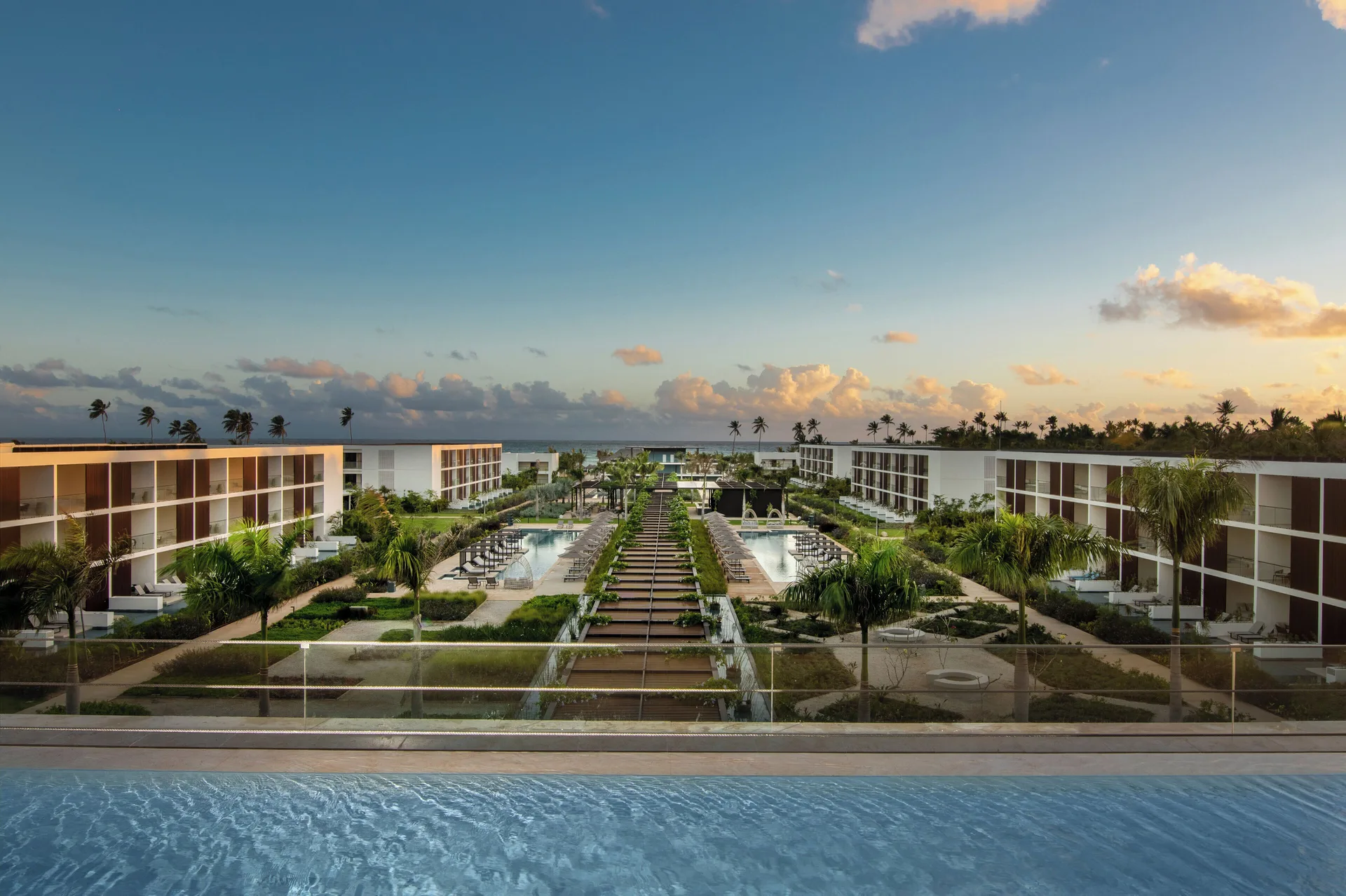 Fuego Suite Partial Ocean View terrace overlooks pools and gardens at Live Aqua Punta Cana.
