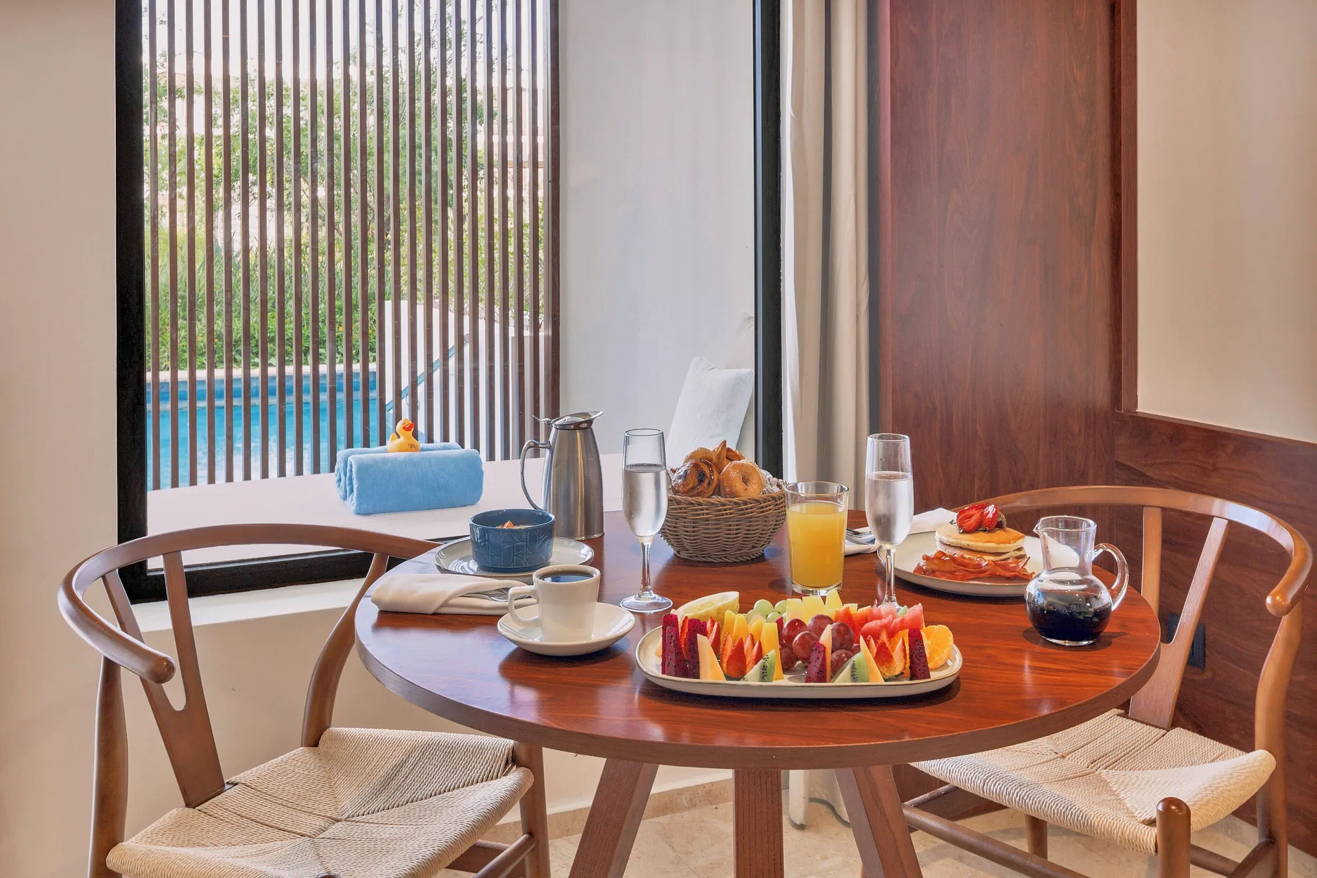 Honeymoon Junior Suite Swim-Up breakfast table by the pool at Live Aqua Punta Cana.