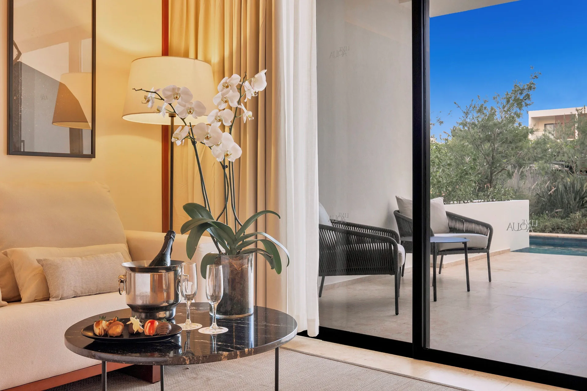 Honeymoon Junior Suite Swim-Up sitting area and terrace at Live Aqua Punta Cana.