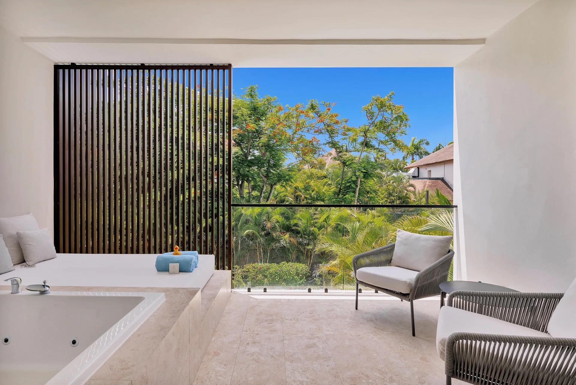 Balcony terrace with soaking tub in a Junior Suite Deluxe Garden View at Live Aqua Punta Cana.