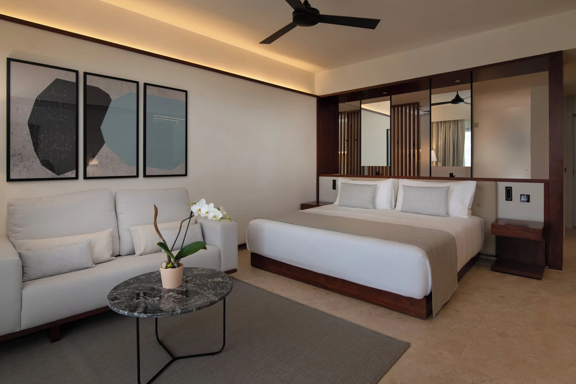 Junior Suite Deluxe Pool View with king bed and sofa at Live Aqua Punta Cana.