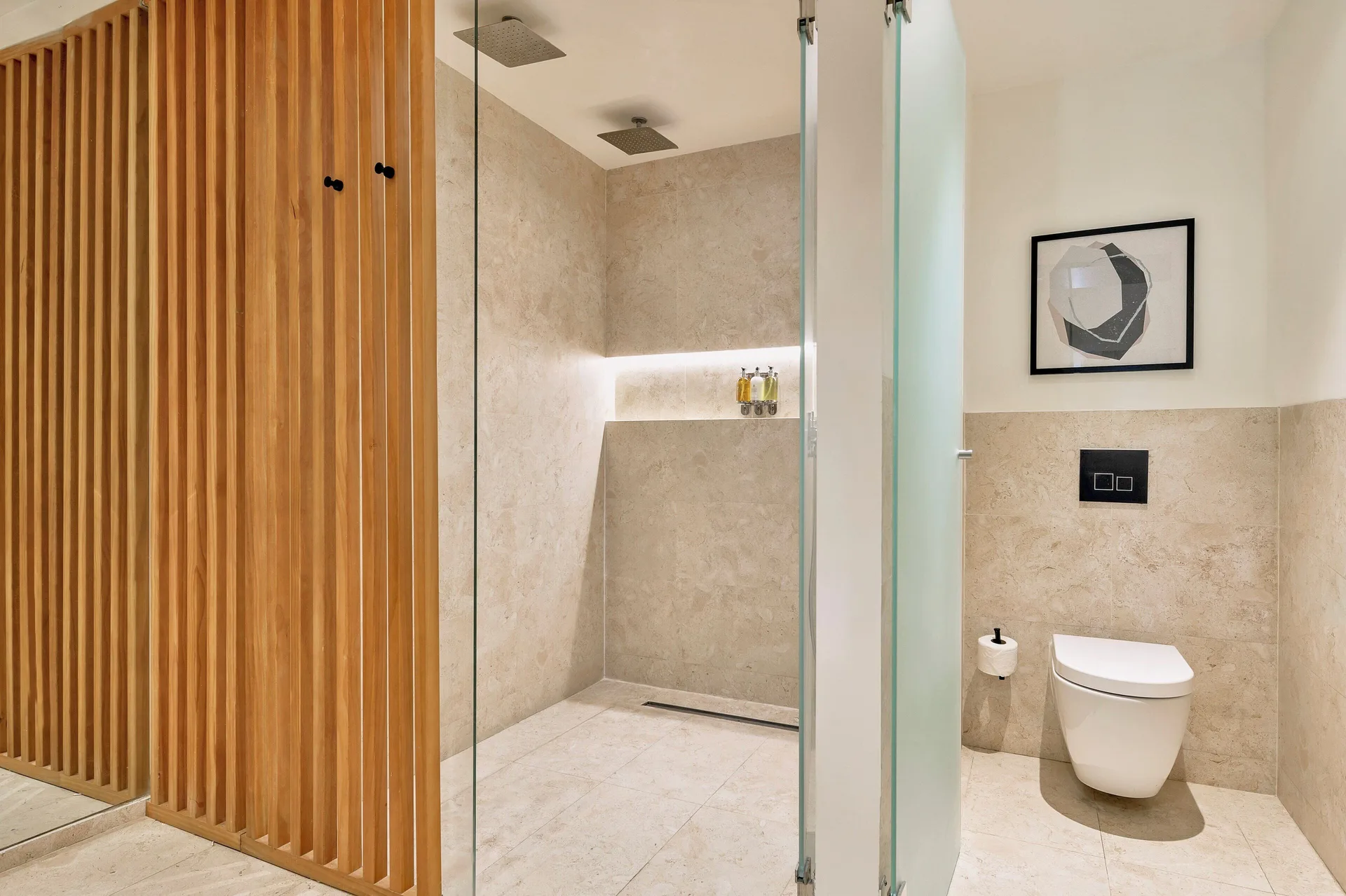 Walk-in shower and toilet in a Junior Suite Deluxe Pool View at Live Aqua Punta Cana.