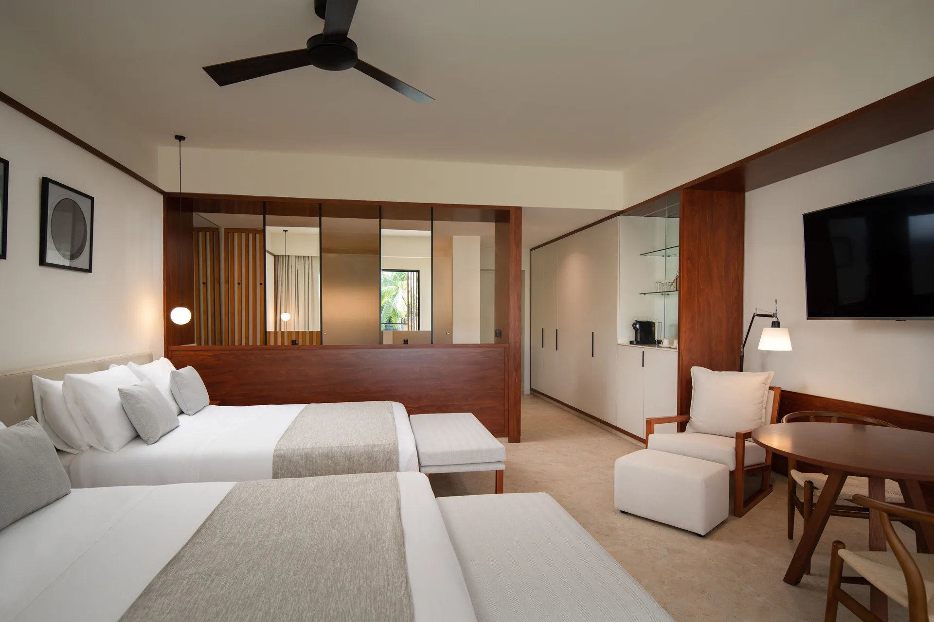 Junior Suite Garden View with two beds and seating area at Live Aqua Punta Cana.
