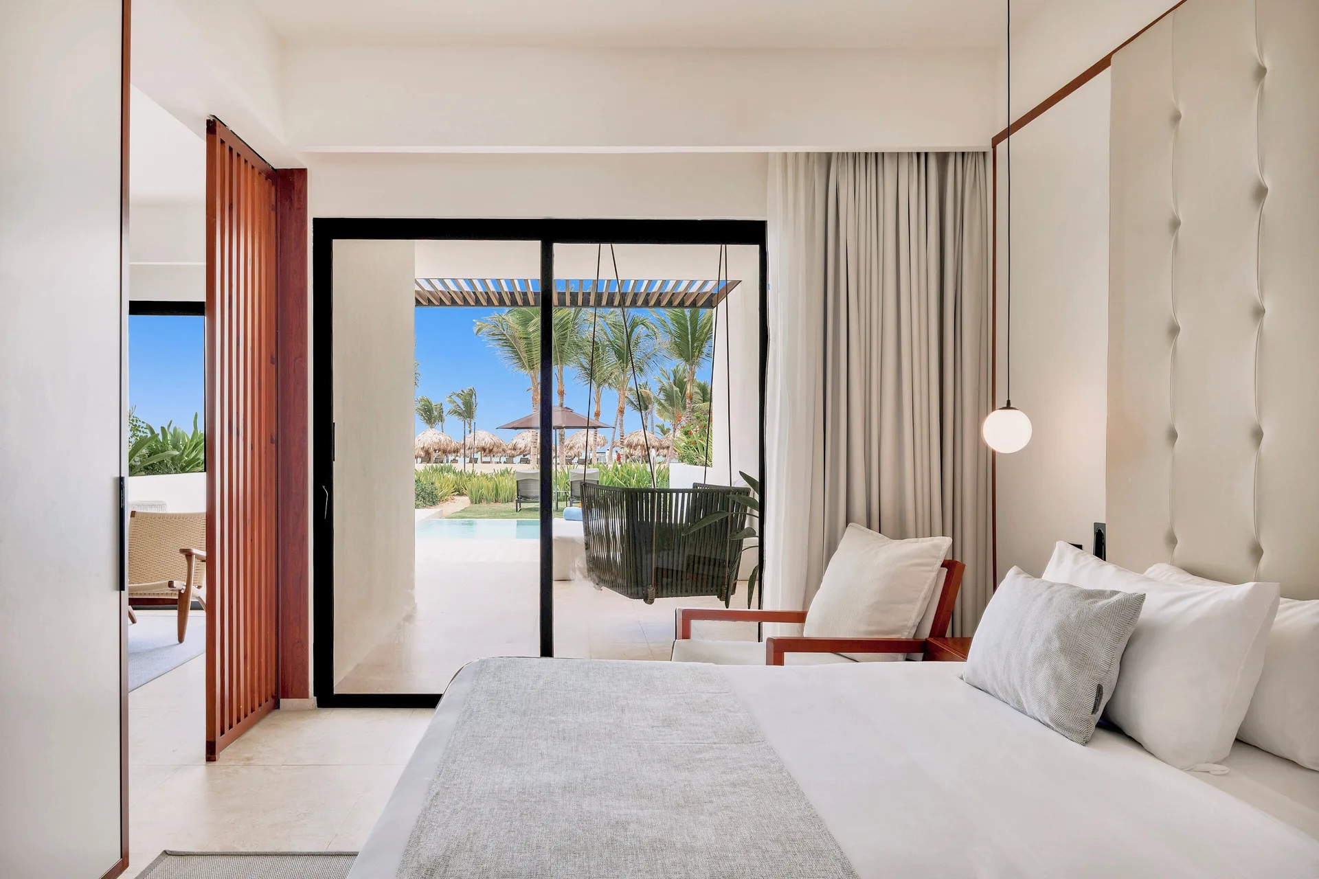 Tierra Suite Ocean Front bedroom with king bed and terrace view at Live Aqua Punta Cana.