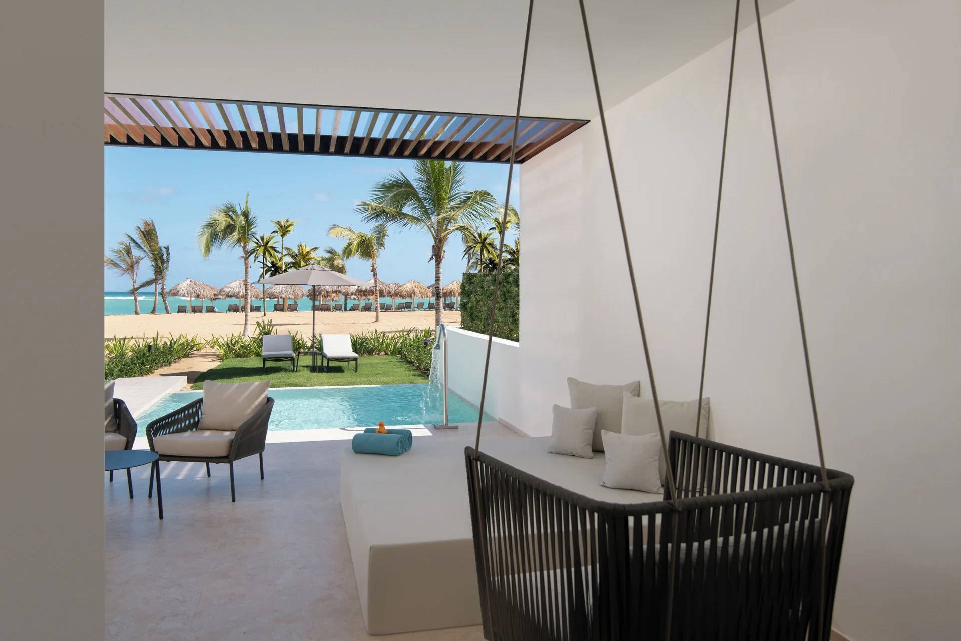 Tierra Suite Ocean Front terrace with swing, plunge pool, and beach view at Live Aqua Punta Cana.