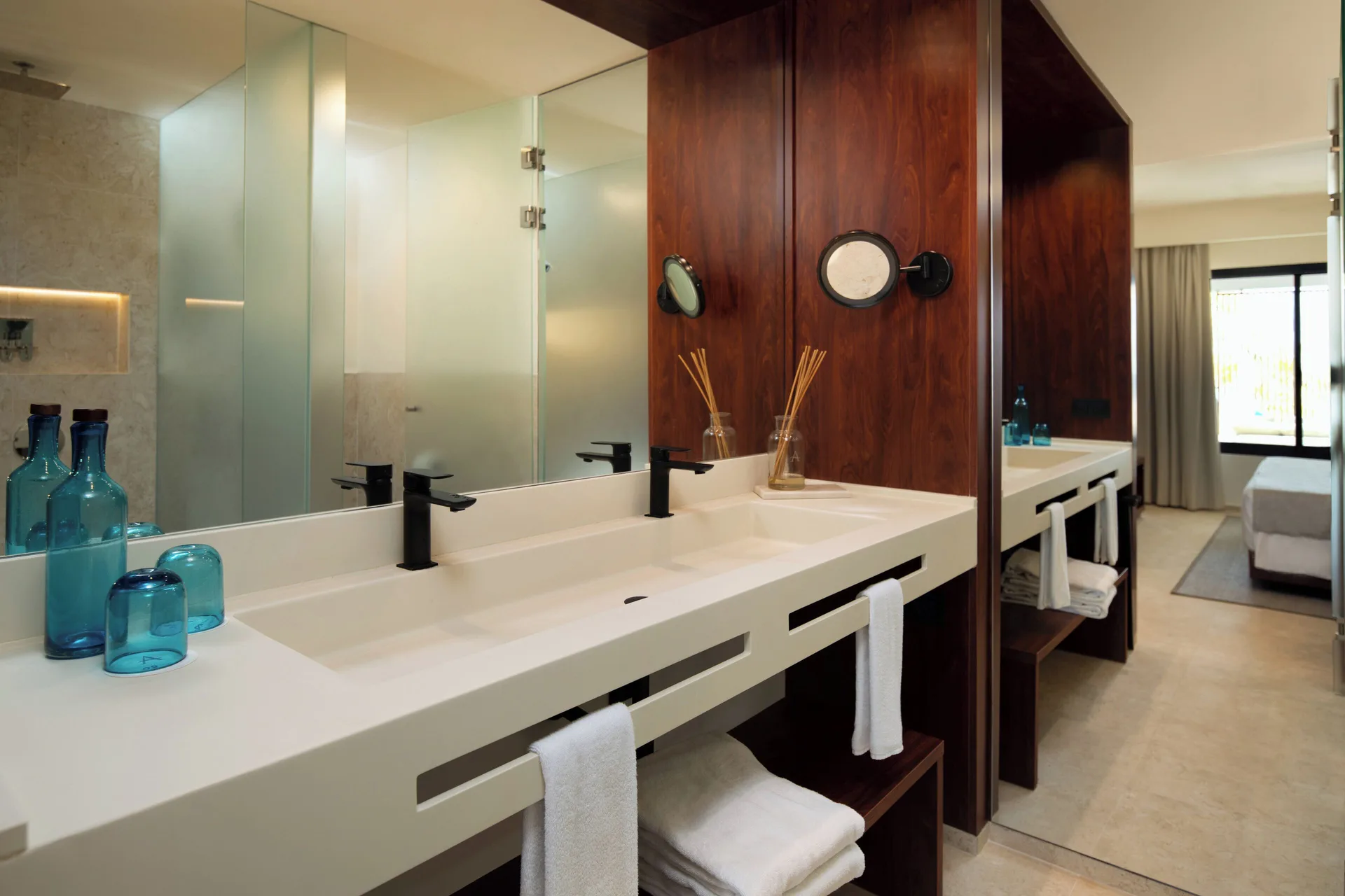 Viento Suite Ocean Front bathroom vanity and bedroom at Live Aqua Punta Cana.