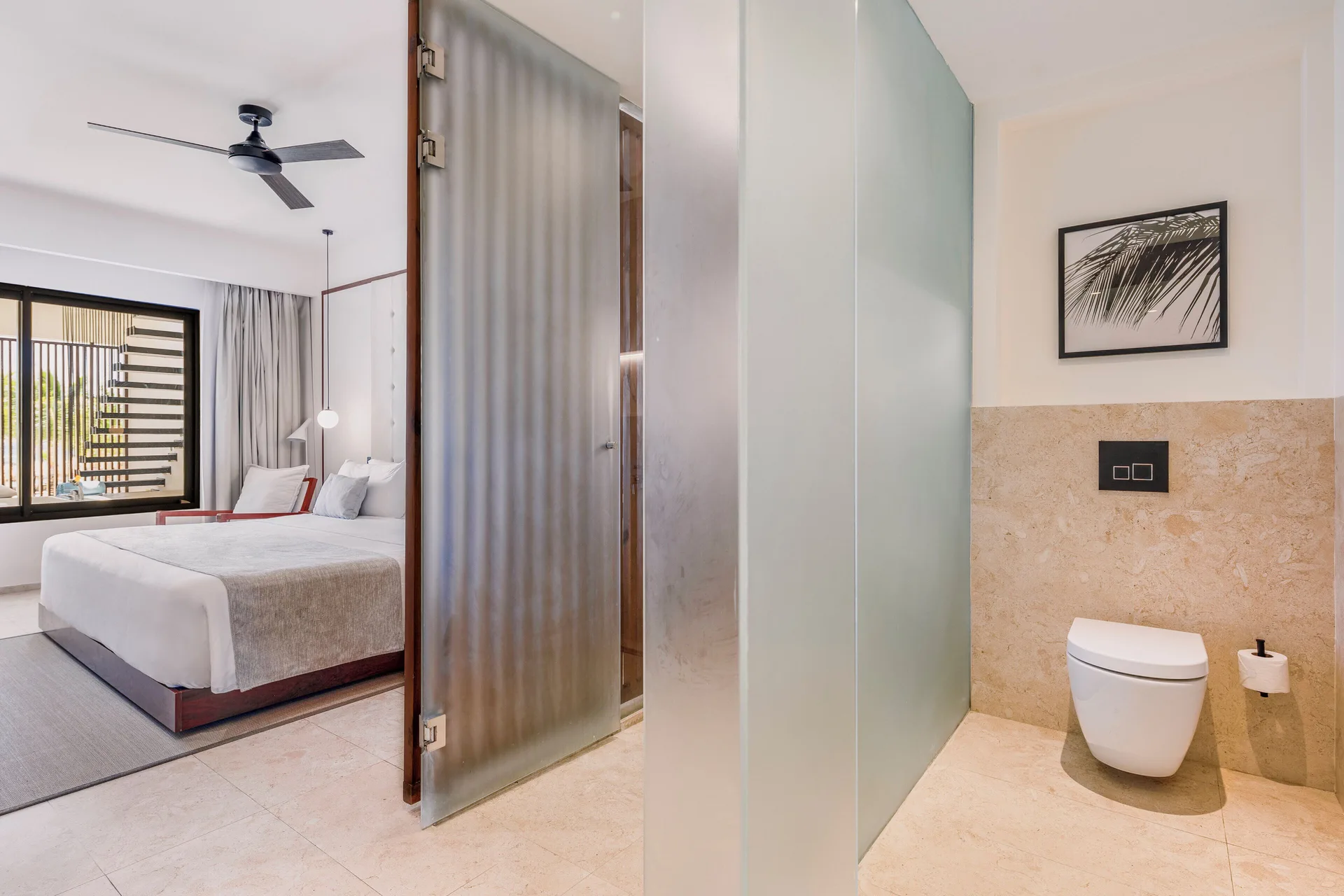 Viento Suite Ocean Front king bed and open bathroom at Live Aqua Punta Cana.