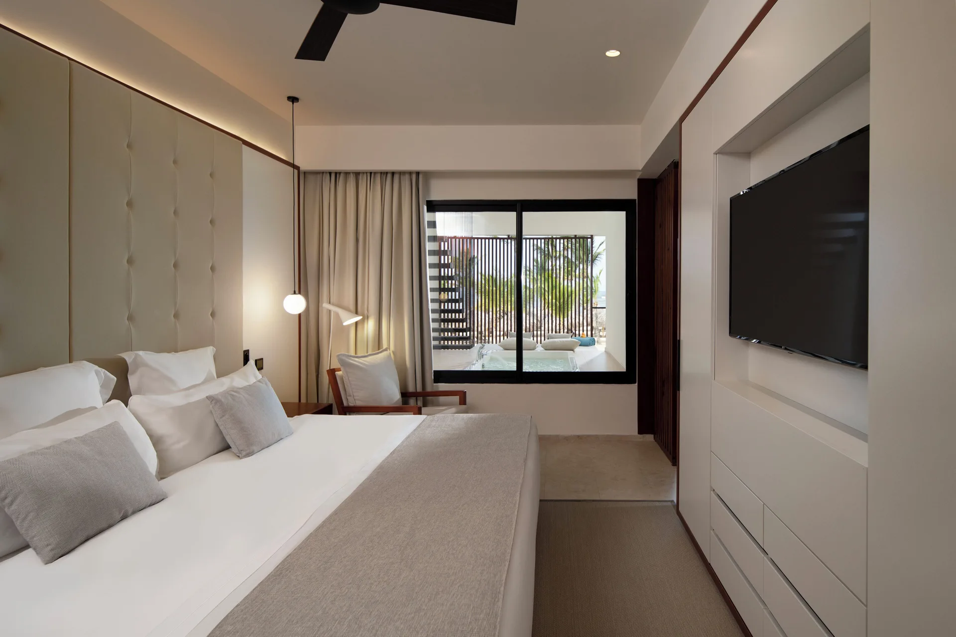 Viento Suite Ocean Front king bedroom with wall TV at Live Aqua Punta Cana.