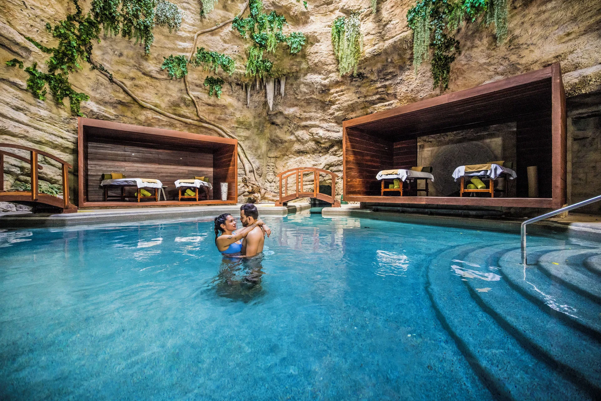 Cave-style spa pool with treatment cabanas at Majestic Elegance Costa Mujeres.