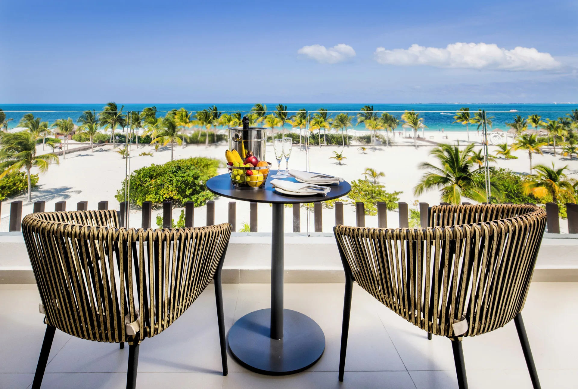 Oceanfront balcony seating with beach and sea view at Majestic Elegance Costa Mujeres.