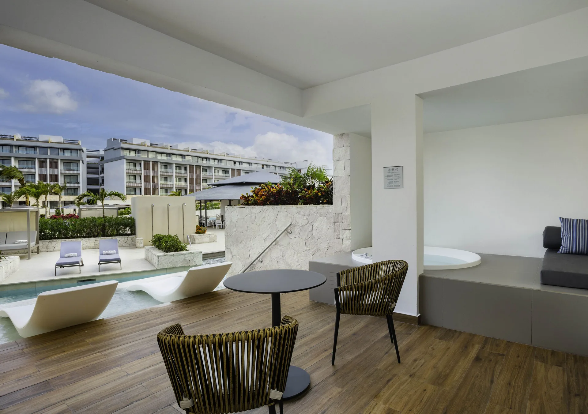 Covered swim-up suite terrace with tub and pool access at Majestic Elegance Costa Mujeres.