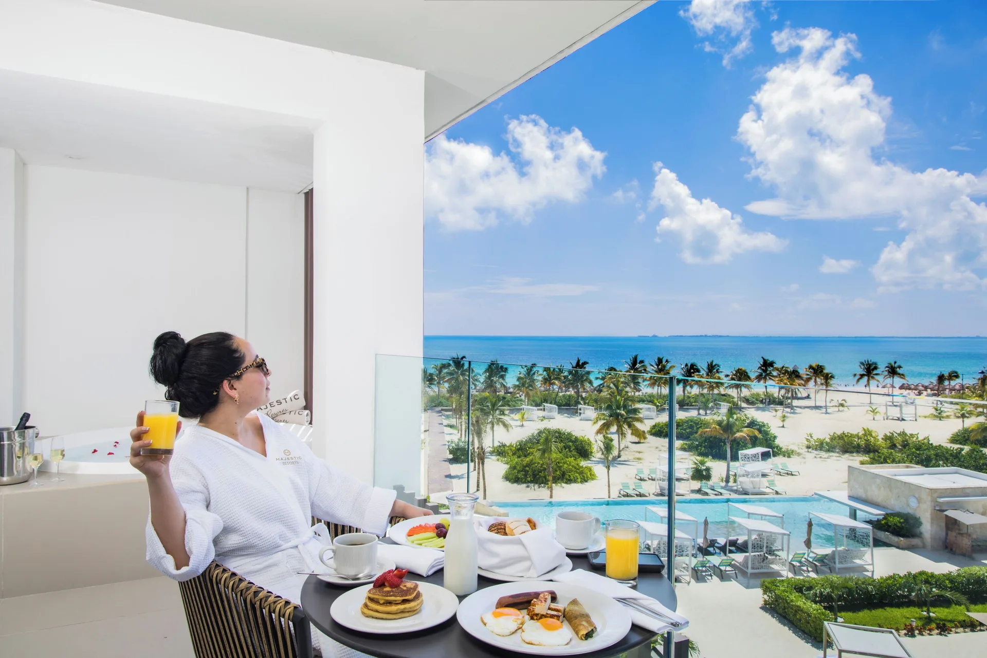 Balcony breakfast and outdoor Jacuzzi view at Majestic Elegance Costa Mujeres.