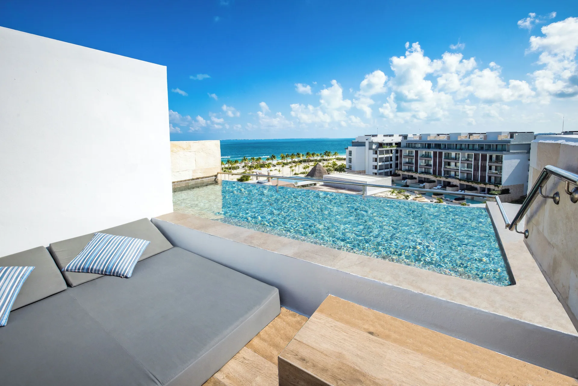 Suite terrace plunge pool and daybed overlooking the coast at Majestic Elegance Costa Mujeres.