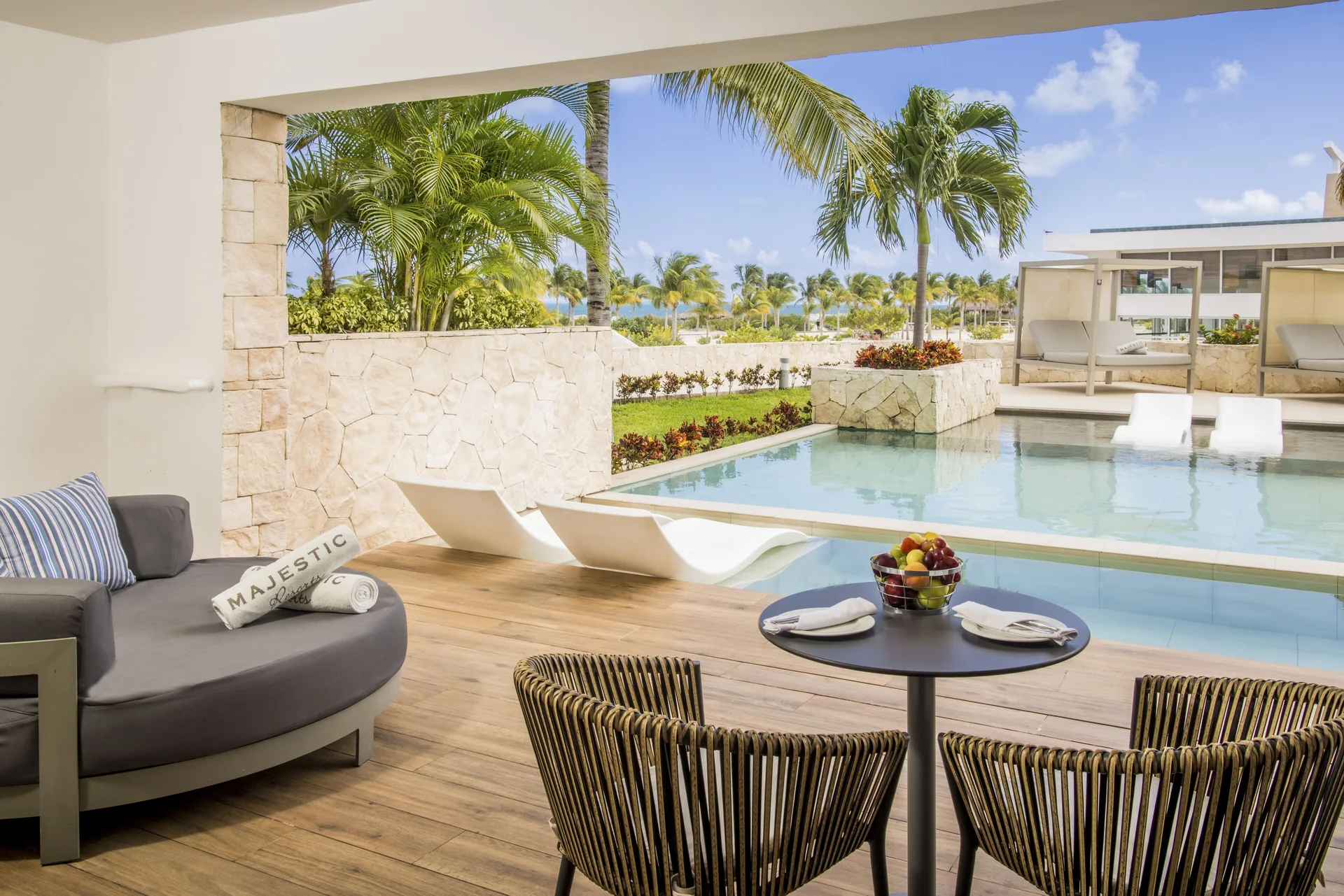 Swim-up terrace with pool access at Majestic Elegance Costa Mujeres.