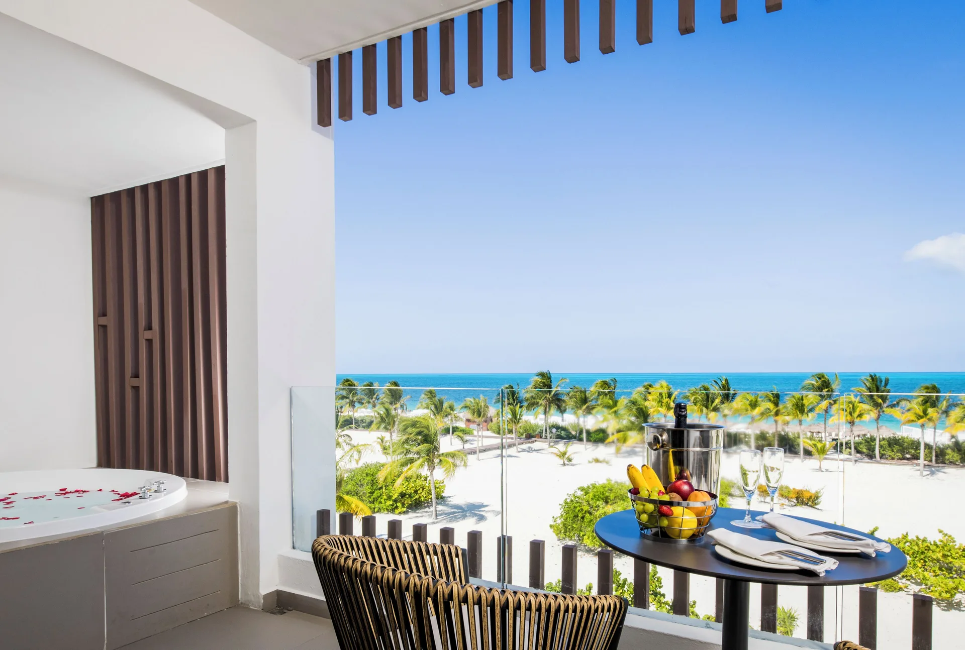 Oceanfront junior suite balcony with outdoor Jacuzzi at Majestic Elegance Costa Mujeres.