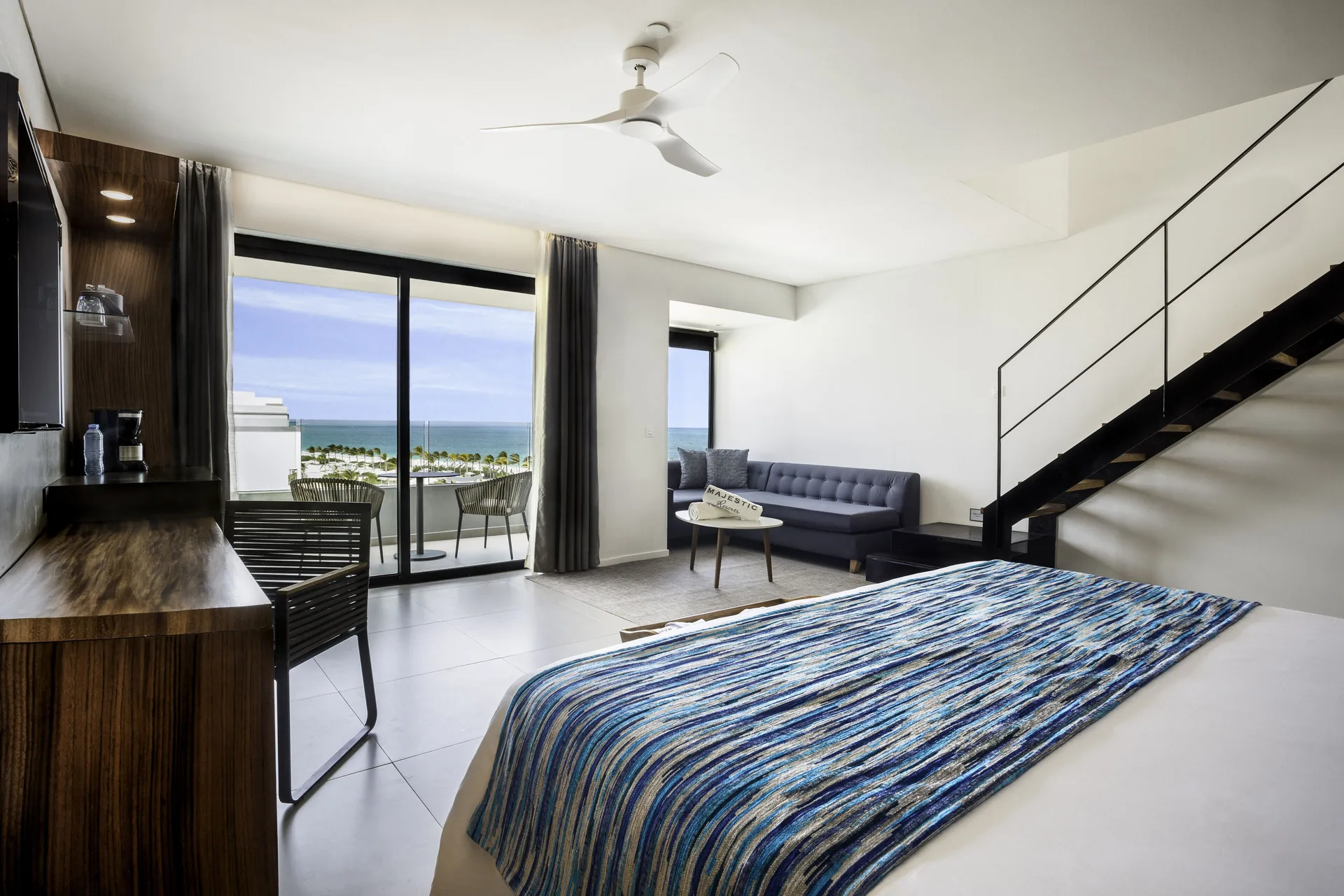 Sky View Suite king bed and balcony ocean view at Majestic Elegance Costa Mujeres.