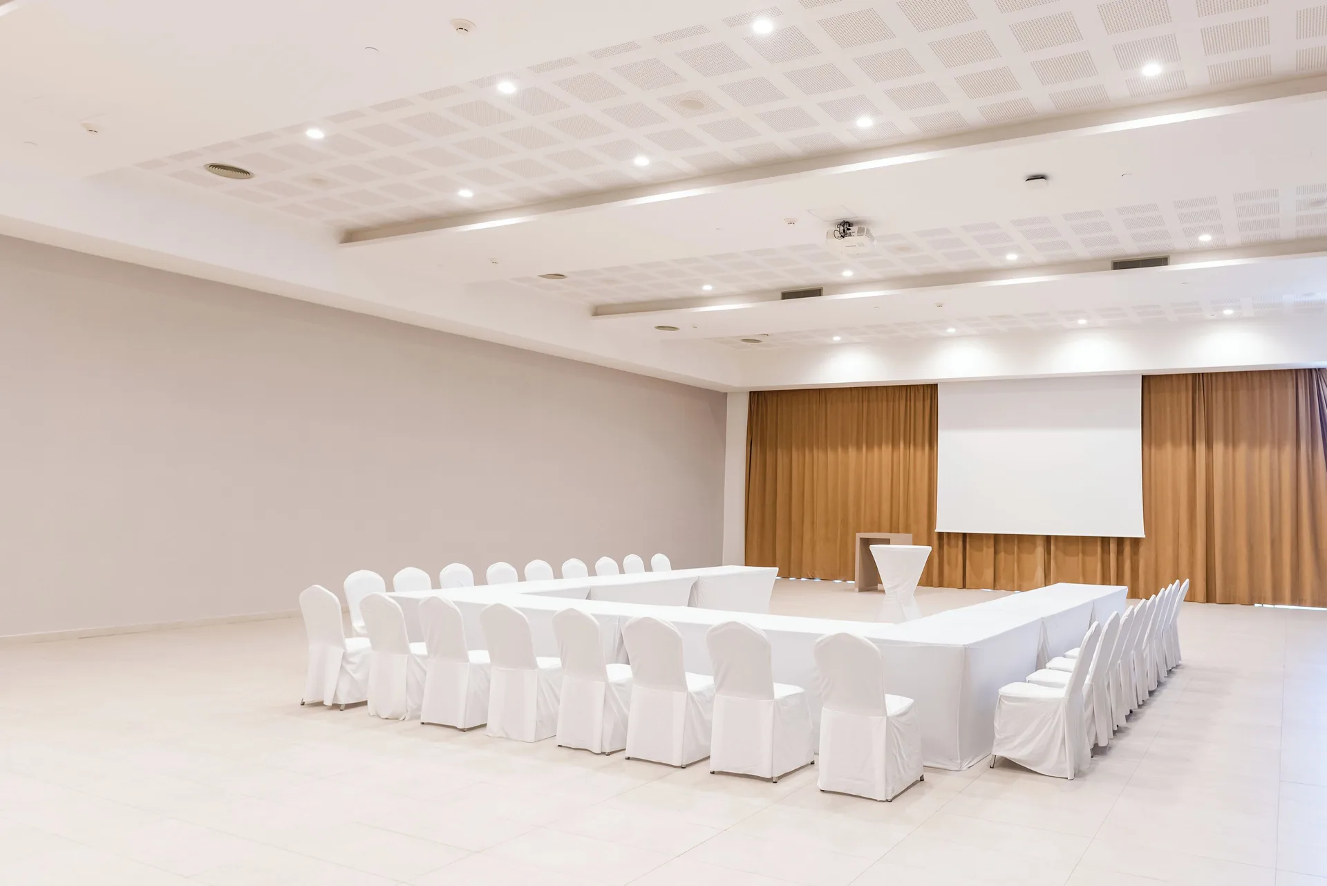 Meeting room with U-shaped table and projection screen at Majestic Elegance Costa Mujeres.