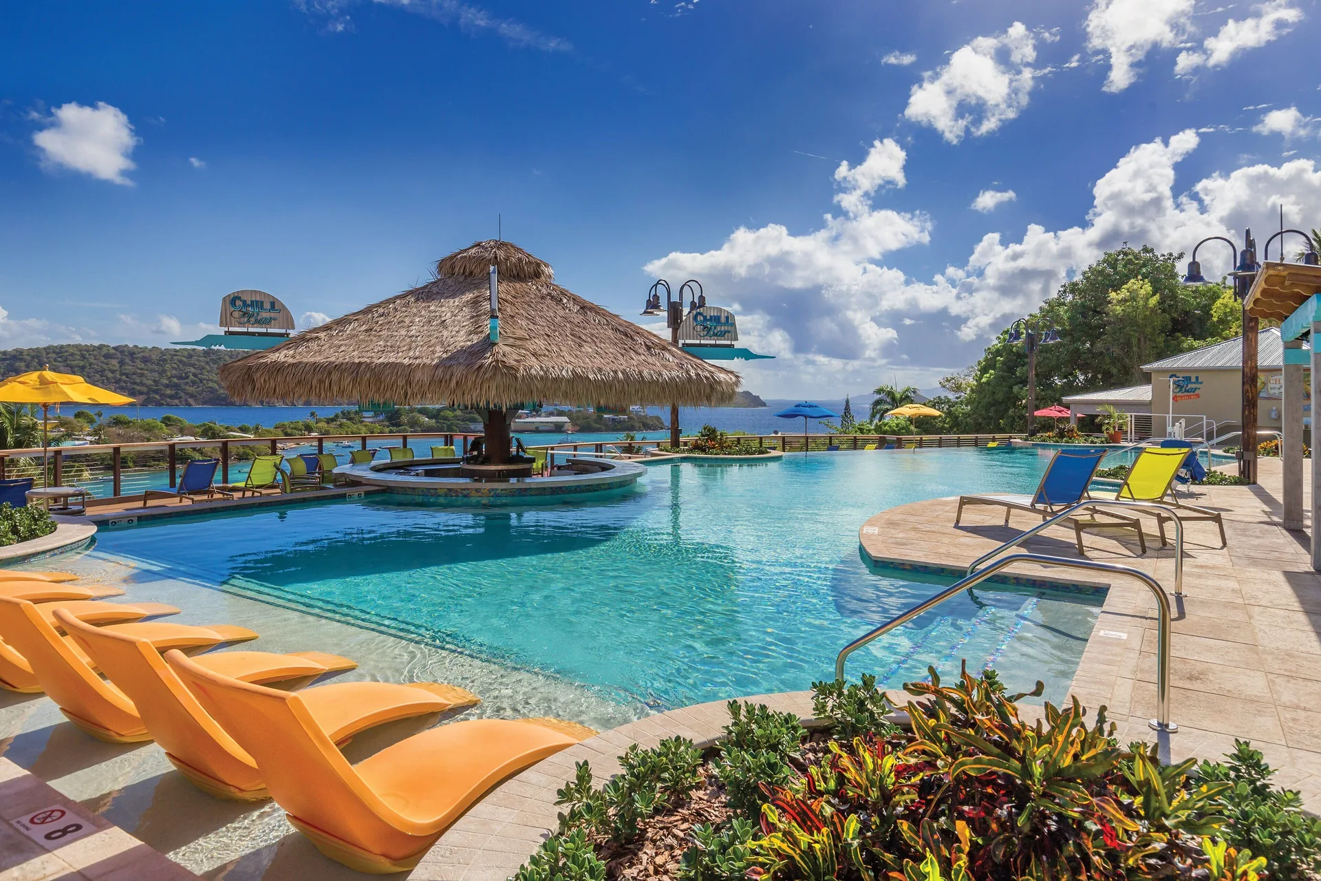Infinity-style pool with thatched shade and bay view at Margaritaville Vacation Club - St. Thomas.