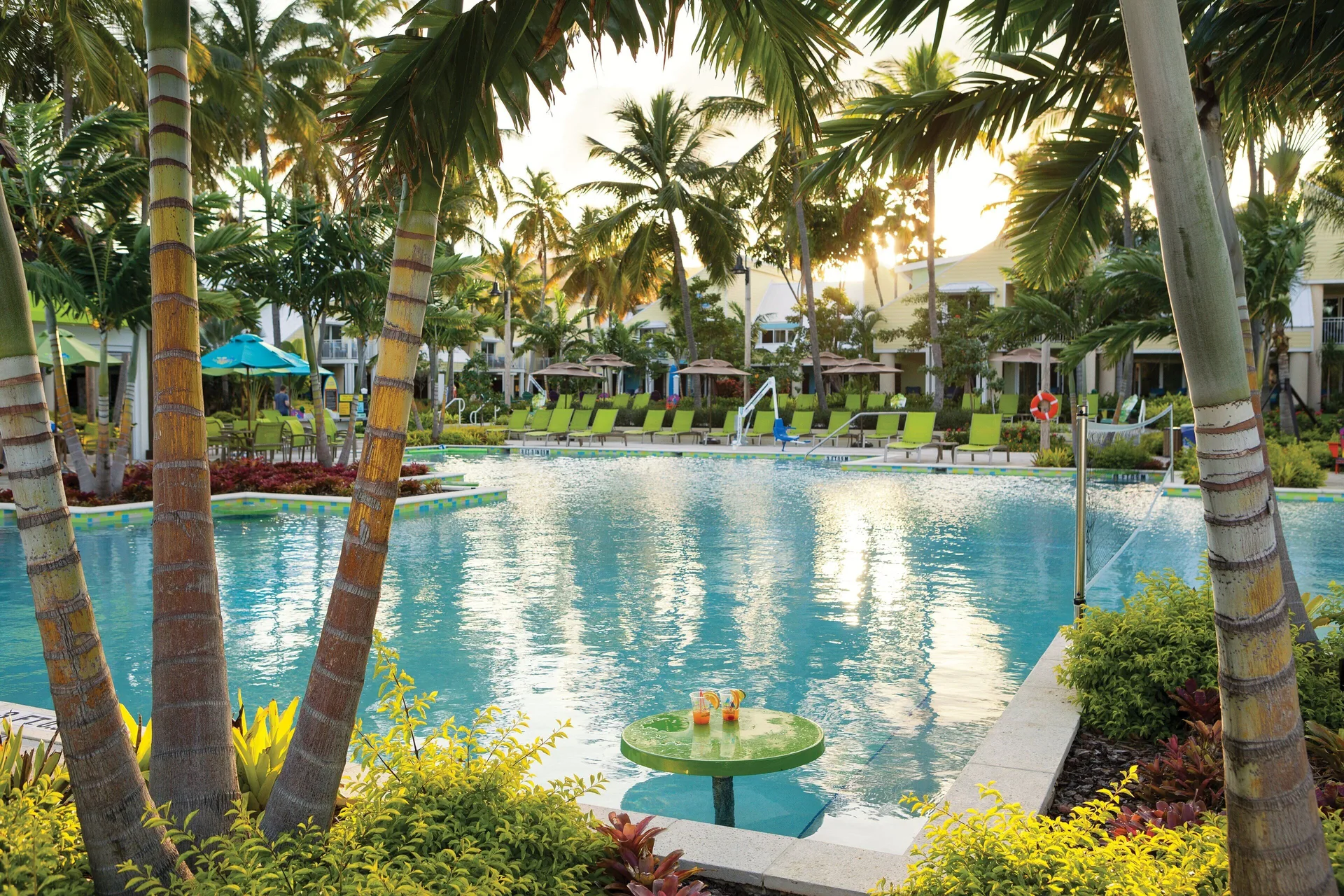 Poolside table with drinks beside palms at Margaritaville Vacation Club - St. Thomas.