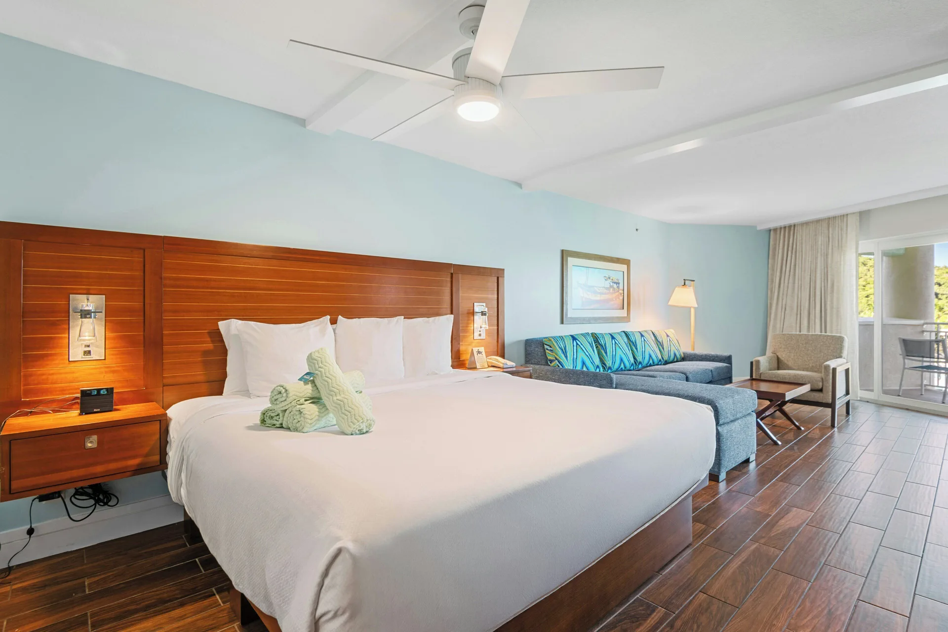 Studio suite king bed and seating area at Margaritaville Vacation Club - St. Thomas.