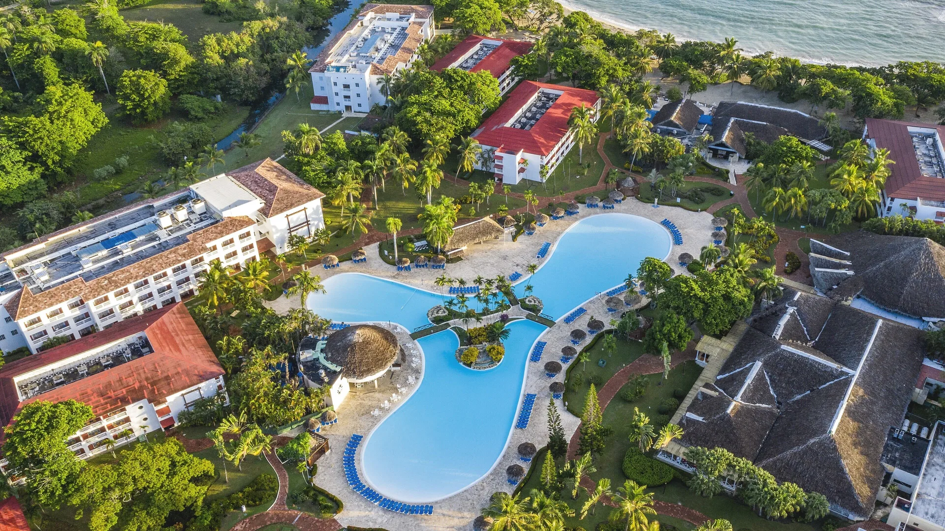 Aerial view of pools, palms, resort buildings and beach at Marien Puerto Plata.