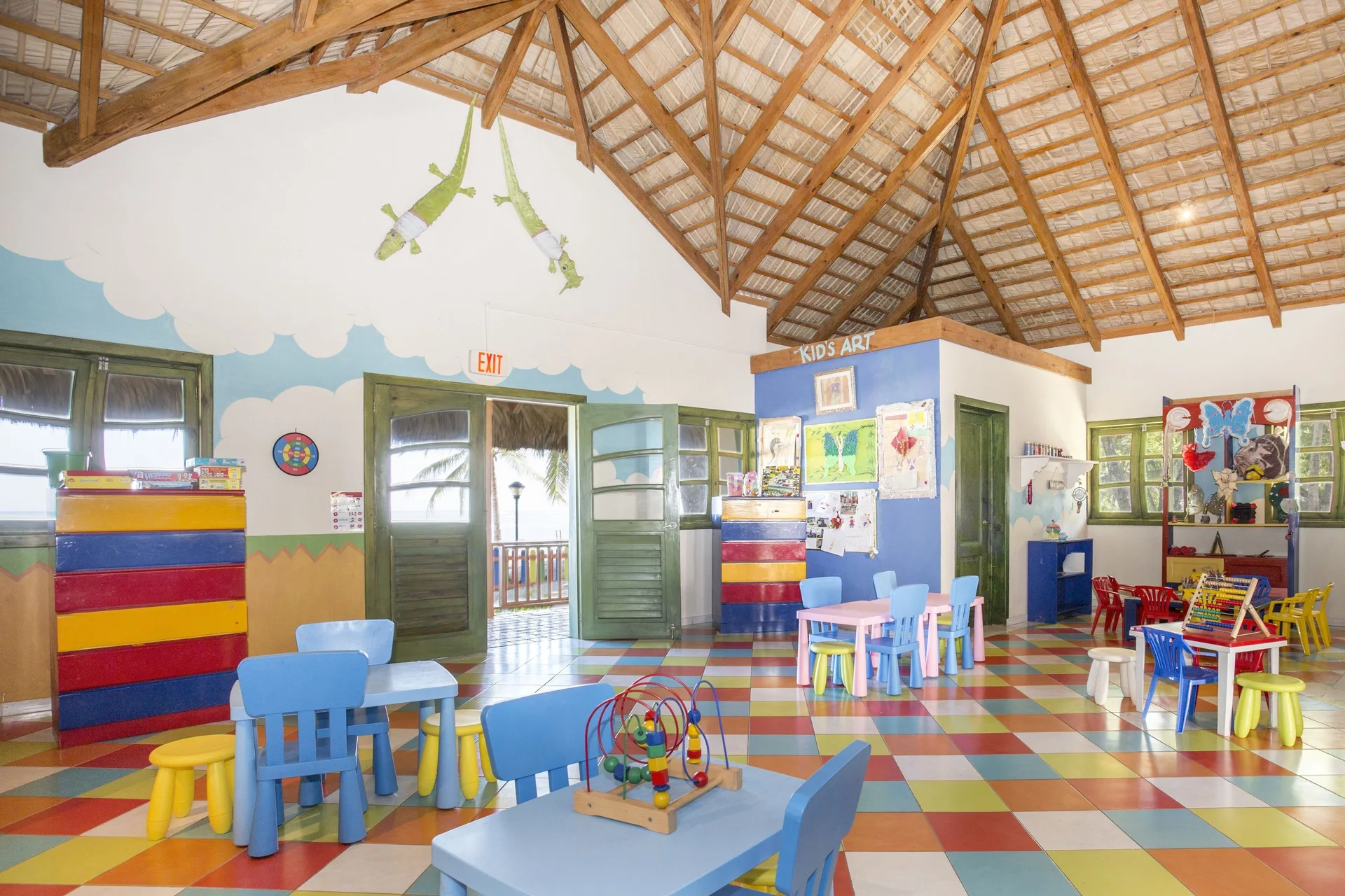 Colorful kids club room with small tables, chairs, and toys at Marien Puerto Plata.