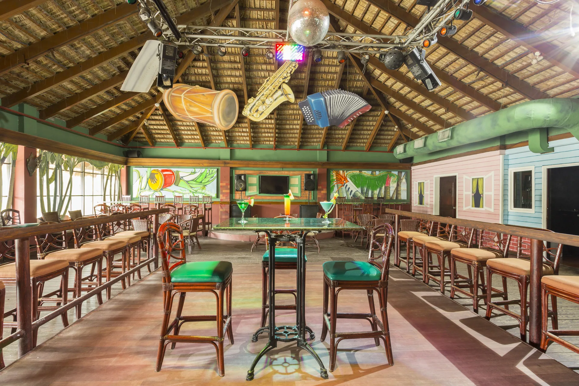 Dance bar tables, stools, lights, and hanging instrument decor at Marien Puerto Plata.